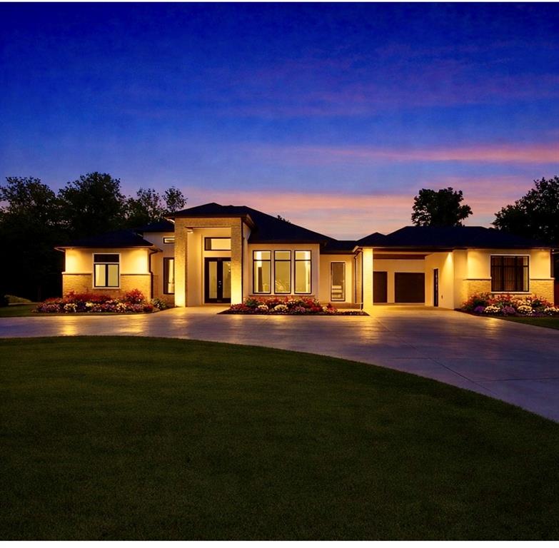 Modern luxury meets premier Nichols Hills living at 2718 W Wilshire Blvd, ideally located around the corner from Oklahoma City Golf & Country Club. This exceptional contemporary residence offers high-end finishes, and a floor plan designed for both entertaining and everyday comfort. Home features huge circle drive with portico leading to oversized 8 car garage with sleek epoxy flooring. Home features 4 bedrooms, 4 bathrooms and 2 powder bathrooms. One half bath is located off back patio. Stunning Study, open dinning room with flex room off from dinning.  Approximately 5,385 sqft. Expansive living spaces are filled with natural light through walls of windows and highlighted with designer lighting and a statement fireplace. The open-concept layout connects seamlessly to the chef's kitchen, creating an ideal setting for gatherings of any size.The kitchen is a true showpiece, custom cabinetry, professional grade appliances includes 6 burner gas Dacor stove, built in double refrigerator, two ice makers and two Miele coffee system in both the kitchen and primary suite. A large wine refrigerator, two dishwashers and plenty of prep space is included in the butler's pantry. The primary suite is a private retreat, featuring an expansive layout with heated flooring sliding patio doors to outside living on the 2,000 sq ft patio. The spa-inspired bathroom with large walk-in shower has his and her vanities and a custom free standing tub.The 3 private bedroom suites provide flexibility and comfort, complemented by spa-inspired bathrooms and generous storage. With one of the rooms located separately by portico. Additional highlights include a whole-home Generac system and a safe room discreetly located within a closet.