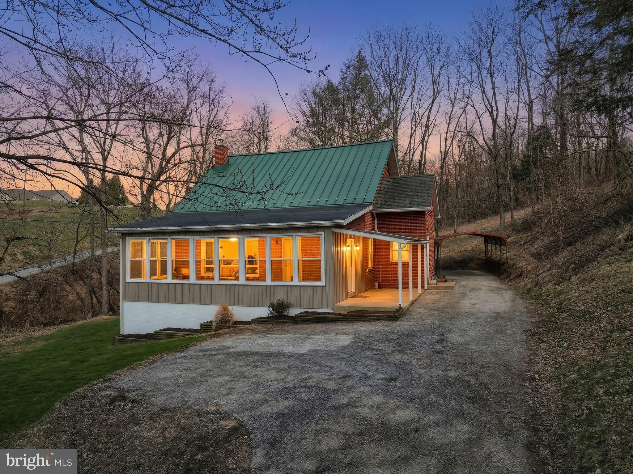 Dallastown Schools. Close to everything but feel like you're in the country on a 1.29 acre lot. Constant deer traffic especially in the fall. Even has a stream running through the property. New windows. New siding. New paint. New flooring. New bathrooms. New lighting. New kitchen (custom plywood cabinets, soft close, counters, sink, faucet, disposal, backsplash). New GE stainless steel appliances. New trim. The main family room is huge (30x15) and has ten large, brand spanking new windows. Two bedrooms on the main level. Full bathroom between the bedrooms, everything is new in the bathroom (tub/surround/glass shower door, toilet, double vanity, fixtures). Not the cheap fixtures here, stainless Delta all the way. Deep fill overflow valve on the tub allows a deep soak.  The backlit mirror even has a defrost mode.  Living room with a half bath right there for the guests. Dining room right off the kitchen. Second level is one huge bedroom with original hardwood floor (didn't want to mess with them...character they say). Basement has outside entrace. 30x15 garage on the lower level. Carport in the rear of the driveway. 23 ft long covered porch.