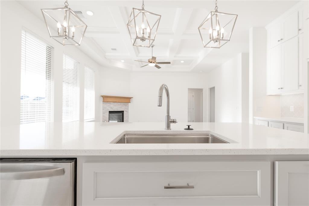 The Hazel floor plan has a total of 2,095 Sqft for living space, including 1,900 Sqft of indoor living and 220 Sqft of outdoor living that features a wood-burning fireplace, a gas line, and a TV hookup! This immaculate home offers 4 bedrooms, 2 full bathrooms, covered patios, a utility room, and a 3-car garage with an in-ground storm shelter installed. The great room presents a beautiful coffered ceiling with a ceiling fan, a gorgeous corner gas fireplace with our stacked stone detail, large 7’ windows, rocker switches throughout, and elegant wood-look tile. The high-end kitchen has stainless-steel appliances, including a 5-burner cooktop, decorative tile backsplash, custom-built cabinets to the ceiling with under cabinet lighting and cabinet hardware installed throughout, a large corner pantry, 3 CM countertops, more wood look tile, stunning pendant lighting, and an oversized center island that holds a spacious sink, a dishwasher, and a trash can pullout. The primary suite spotlights a sloped ceiling detail with a ceiling fan, windows, and our cozy carpet finish. The spa-like prime bath has a free-standing tub, a dual sink vanity with framed mirrors, 3 CM countertops, a European walk-in shower, a private water closet, and a huge walk-in closet with horizontal and vertical storage opportunities. Secondary bedrooms feature high ceilings with ceiling fans, sizeable closets, windows, and carpeted flooring. Other amenities for this energy efficient home include a tankless water heater, a fresh air ventilation system, R-44 and R-15 insulation, and so much MORE!