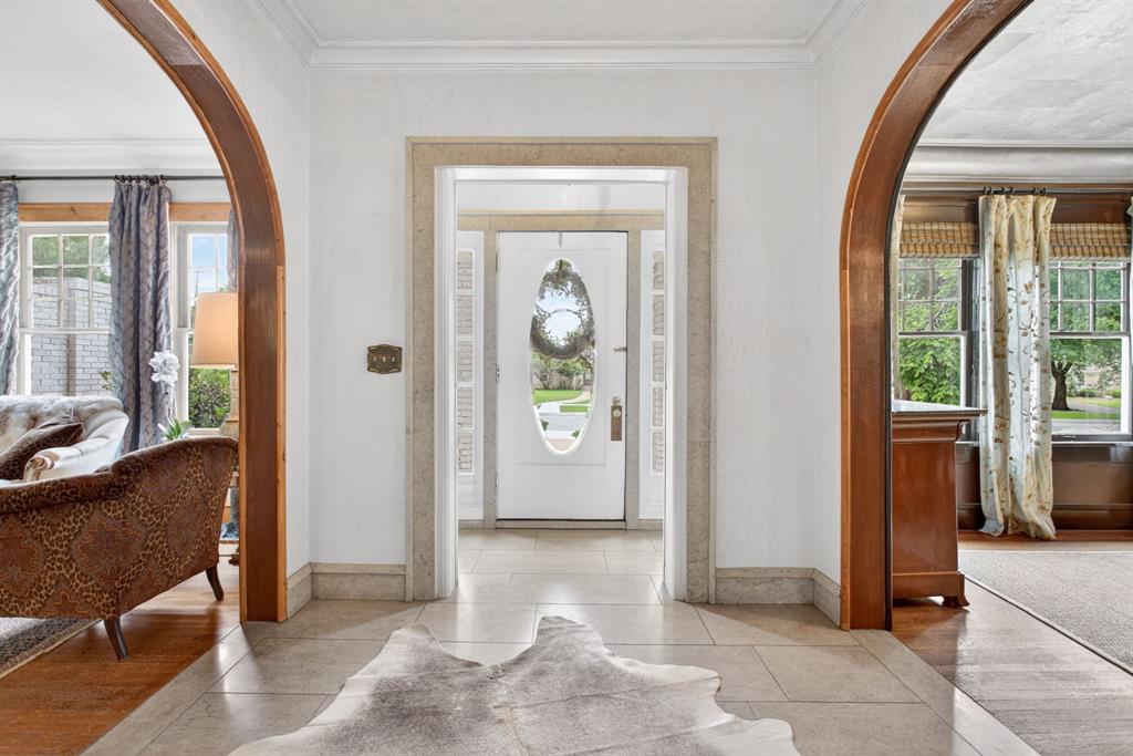 Just minutes away from downtown Fort Worth, TCU and the medical district is the beloved Ryan Place neighborhood and historic home on eponymous Elizabeth Boulevard. The 5-bedroom, 4-bath plus powder room spans more than 5,000 square feet. Upon entering the home you are greeted with original hardwood floors and limestone slab walkways, rich textures, designer tile work and wallpaper, curated antique light fixtures and thoughtful period details. The first floor features an expansive light-filled living area, large formal dining and domed hallway featuring Venetian plaster that leads to the kitchen, breakfast room and butler’s pantry. The eat-in kitchen boasts Subzero refrigeration, Wolf range and custom cabinetry. The breakfast room looks onto the garden and pool as well as an extensive arbor to the garage, cabana and carriage house. Completing the first floor is a sunroom featuring double French doors that open to an imported European fountain and private courtyard with additional French doors to the backyard spaces and dine al fresco, soak up the sun or enjoy the warmth of an outdoor fireplace. Chicago brick walkways and hardscaping complement the lush garden and mature trees. The home’s second floor boasts two master suites and two additional bedrooms with Jack and Jill bath. A multi-paned, steel frame, triple laminated safety glass skylight floods the stairway in light, directing you to the third floor featuring a bedroom wrapped with cork tiles currently used as an office, full bath, billiard room and large family room. Outside, the oversized two-car garage opens to the cabana featuring hand-carved wood lockers and full bath. Upstairs the nearly 1,500 square foot carriage house has a bonus loft for additional sleeping or its current workout area. Experience the classic charm and thoughtful design of this private estate in one of Fort Worth’s most beloved historic neighborhoods.
