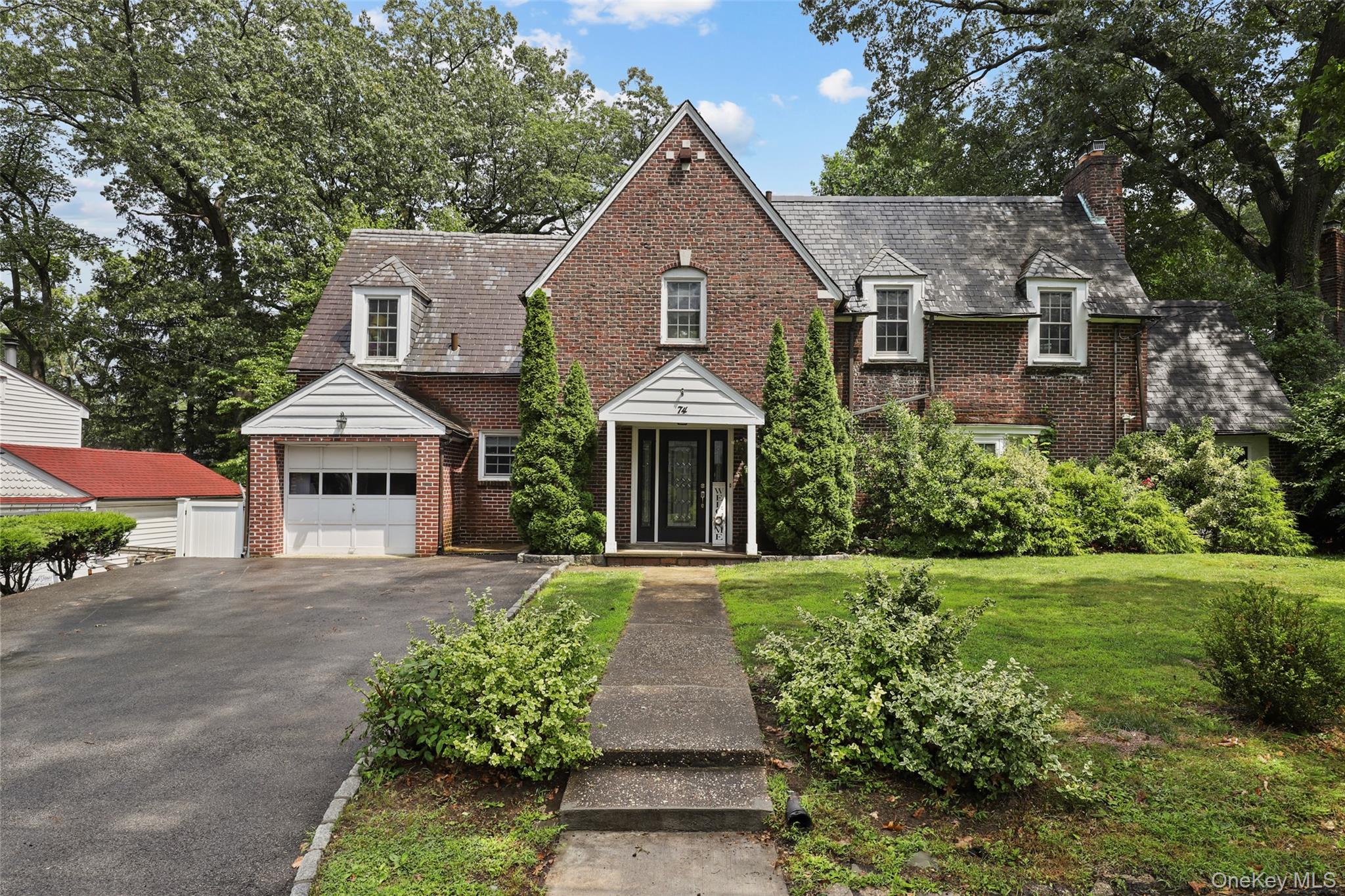 Timeless Tudor Charm in Colonial Heights Welcome to 74 (also known as 84) Chester Drive, a stunning 1928 Tudor-style home located in the heart of Yonkers’ desirable Colonial Heights neighborhood. Brimming with character and thoughtfully updated for modern living, this spacious residence offers 3 bedrooms, 2.1 baths, and 2,355 sq ft of comfortable elegance on a .17-acre level lot. Step inside to discover charming architectural details, including hardwood floors, leaded glass windows, and arched doorways—all paired with a brand-new kitchen designed for modern convenience and style. The generous layout features bright, airy living and dining spaces, perfect for both everyday living and entertaining. Outside, enjoy the ease of a double-wide driveway and the comfort of a large deck overlooking a flat, fully usable yard—ideal for gatherings, relaxing weekends, or gardening. Located just minutes from the vibrant villages of Tuckahoe and Bronxville, this home offers effortless access to local shopping, dining, and cafes. Commuters will love being close to the Tuckahoe Metro-North Station, offering a quick 30-minute ride to Grand Central. Nearby Central Park Avenue and the Cross County Shopping Center provide even more retail and restaurant options, while local parks, scenic trails, and access to the Bronx River Parkway make it easy to enjoy the outdoors. Whether you're drawn to the charm of a historic Tudor, the ease of updated interiors, or the unbeatable proximity to shops, transit, and amenities, this home offers it all. Don’t miss your chance to experience the best of Colonial Heights living.