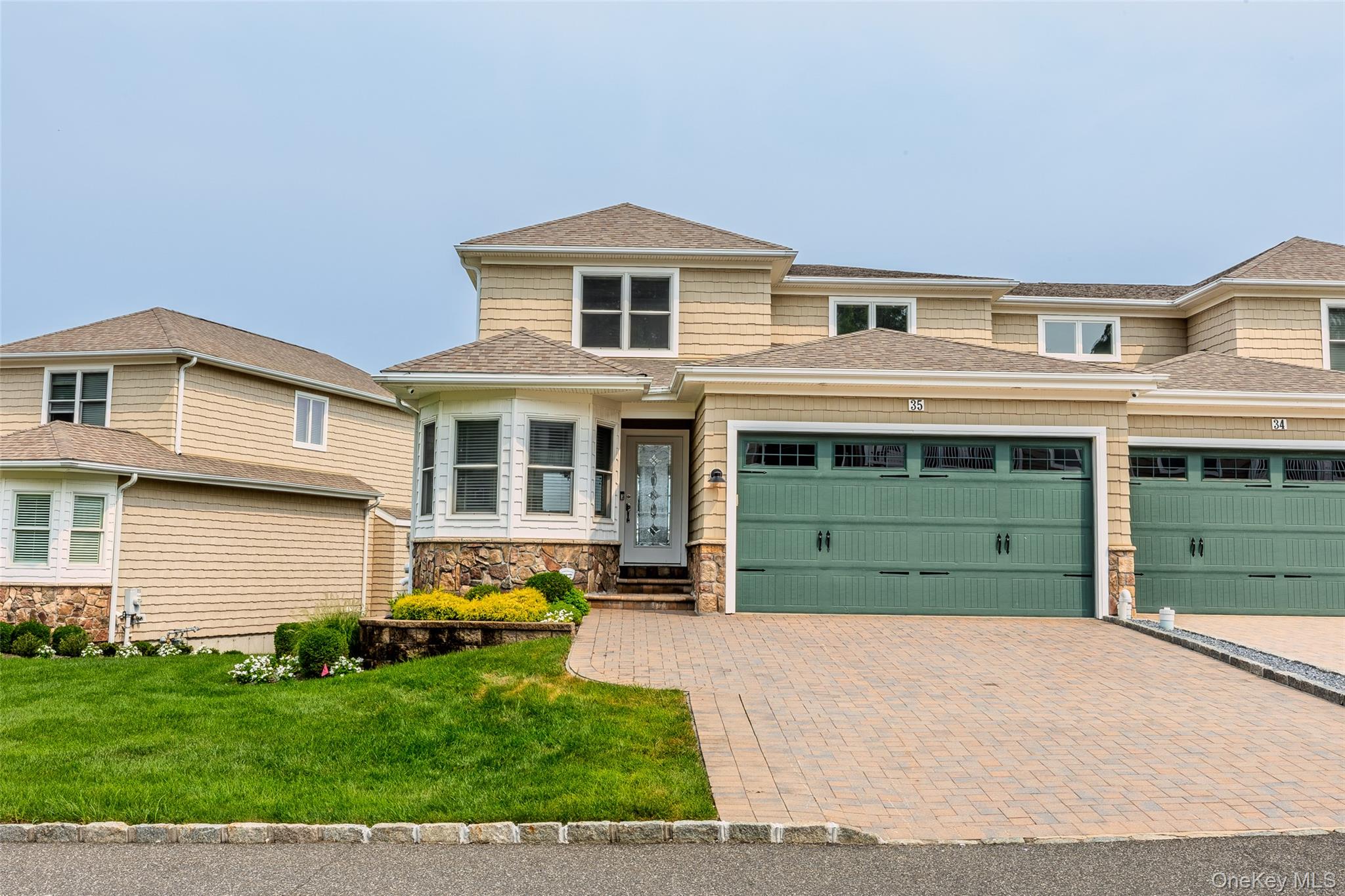 Here is your opportunity to make an exquisite townhome with a water view of your own.  Village Vista's is a 55 and better community located in the heart of Port Jefferson Village.  Enter the home on the main level and look across the open floor plan and see the beauty of the Long Island Sound and the pastoral, peaceful views behind your home.  This home boasts three comfortable levels with your own personal elevator, whole-house generator, a roll-up awning over the rear trex deck off the living room, Anderson windows and sliding doors throughout, and two fireplaces.  To complete the splendor, the primary bedroom with an ensuite is located on the 1st floor. On the upper level, there are two additional bedrooms; one bedroom offers a sliding door to a trex deck.  Also upstairs, there is a Jack & Jill bathroom and a comfortable loft with an eye-catching water view.  This home also offers a coffered ceiling, paver driveway, and a two-car attached garage.  The gourmet bright white kitchen has a large marble island, stainless steel appliances, and marble flooring.  The lower level of this home is finished with a family room, full bathroom, laundry room, and a storage room.  This home is an absolute gem and will not last.