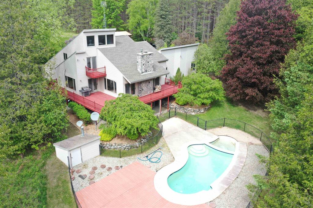PRIVATE RIVERFRONT RETREAT ON APPROX. 61 ACRES - Just Minutes from West Branch. Enjoy peace, privacy, and great hunting on this stunning 3-bed, 3.5-bath home with ‚ ±3,654 sq. ft. of living space, set on approximately 61 acres with ‚ ±825 ft. of frontage on the West Branch of the Rifle River. Less than 5 miles from town, this property offers a paved ‚ ¼-mile driveway, abundant deer, turkey, and small game, and frequent wildlife visits right to the yard. The river hosts trout and a solid spring run of steelhead, and views from the home are beautiful year-round. The spacious master suite features two walk-in closets and an ensuite bath; another bedroom also has a walk-in. The large island kitchen includes a pantry and flows into open living space with a wood-burning fireplace on the main floor and a gas fireplace in the finished walk out lower level. Additional features include a newer roof, furnace, and central air, attached 2-car garage, a 20x24 detached garage/pole barn, and an in-ground pool. The basement offers 1,300 sq. ft. of finished space, a ‚ ¾ bath, and ample room to add an additional bedroom. Enjoy outdoor living on the wraparound riverside deck, surrounded by tasteful landscaping. This is the complete Up North lifestyle-seclusion, recreation, and comfort in one rare offering.