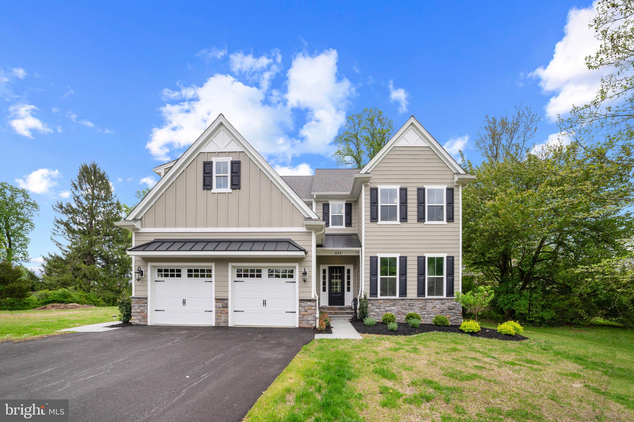 An exclusive opportunity to own new construction in a highly desirable walk-to-Malvern location. This thoughtfully designed home sits on a quiet street in Malvern Borough and features a spacious, level backyard ideal for everyday living and entertaining. Striking curb appeal showcases cement board siding, metal roof accents, and classic fieldstone details. A covered front entry with elegant flagstone leads into a bright, welcoming foyer. The main level features gleaming hardwood floors, enhanced by crown molding, custom millwork, and wainscoting throughout. Off the foyer, glass French doors open to a generous home office, which connects seamlessly to the formal dining room through a second set of glass doors. The dining space is beautifully appointed with detailed wainscoting and a chandelier, creating the perfect setting for gatherings and celebrations. At the heart of the home is the open-concept kitchen and family room. The kitchen boasts a large 4x8 island with built-in cabinetry and microwave, solid wood white cabinets, quartz countertops, a 6-burner cooktop, double ovens, and a stylish bar area with glass cabinetry and a beverage refrigerator. The adjoining family room features a cozy gas fireplace with custom shiplap surround. A bright breakfast area with sliding doors leads to a paver patio, offering easy indoor-outdoor living and views of the expansive backyard. The first floor also includes a well-designed mudroom off the two-car garage, complete with custom cubbies, shelving, and additional closet space. Upstairs, the primary suite is filled with natural light and includes a large walk-in closet and a luxurious en-suite bathroom. The spa-inspired bath features elegant tilework, a soaking tub, a spacious glass-enclosed shower with bench seating, dual vanities, and a private water closet. A second bedroom offers its own en-suite bath with a tiled walk-in shower. Two additional bedrooms are generously sized with ample closet space and share a Jack-and-Jill bathroom with double sinks and a full tub. A convenient second-floor laundry room includes tile flooring, a stainless steel sink, and built-in cabinetry. The lower level provides abundant storage with high ceilings, an egress window, and a poured concrete foundation. This area will be finished with an additional full bathroom and approximately 1000 sq ft of Living Space between 3 separate rooms including a potential 5th Bedroom. Ideally located on quiet Highland Avenue, this home is just a short walk to downtown Malvern’s shops, dining, and parks, offering both convenience and charm. Award Winning Great Valley Schools and a short walk to downtown Malvern and Playground, come see it today! *Taxes with new construction to be assessed by County Assessor after closing*