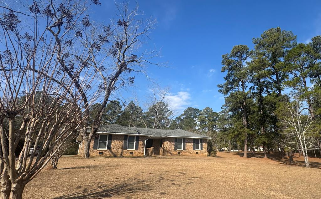 Great brick home in the Country Club Estates neighborhood.  This home features 4 bedrooms and 2 full bathrooms.  A spacious dining room with a kitchen that has upgraded with quartz countertops.  The family room features a wood burning fireplace.  There are beautiful floors throughout this home and it has been freshly painted.  The master suite has updated quartz vanity, luxurious tub for relaxing, and a large designed shower.  There are also new appliances and updates in the kitchen.  This property is close to downtown, schools, & shopping.  It is a rare gem and a must see property.  The golf course is within walking distance too!  Call listing agent or your favorite realtor today!