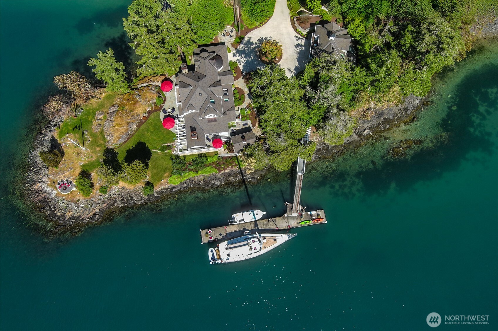 Stunning 1.21-acre San Juan Island estate with 578’ of waterfront and private 100’ deep-water dock. Fully remodeled main home (3,007 sq ft) plus a 794 sq ft guest house, bunk house, barn, and fenced garden. Light-filled interior features high ceilings, chef’s kitchen, study, sunroom, and main-level ensuite—all with water views. Second parcel includes barn with storage and potential for future expansion. Ideal for boaters and seaplane owners with dock, mooring buoy, and ample outdoor entertaining space. Peaceful setting, thoughtful design, and year-round access make this a rare legacy property for relaxed island living. Enjoy sunrise coffee by the shore, sunset dinners on the deck, and seamless access to the best of the San Juans.