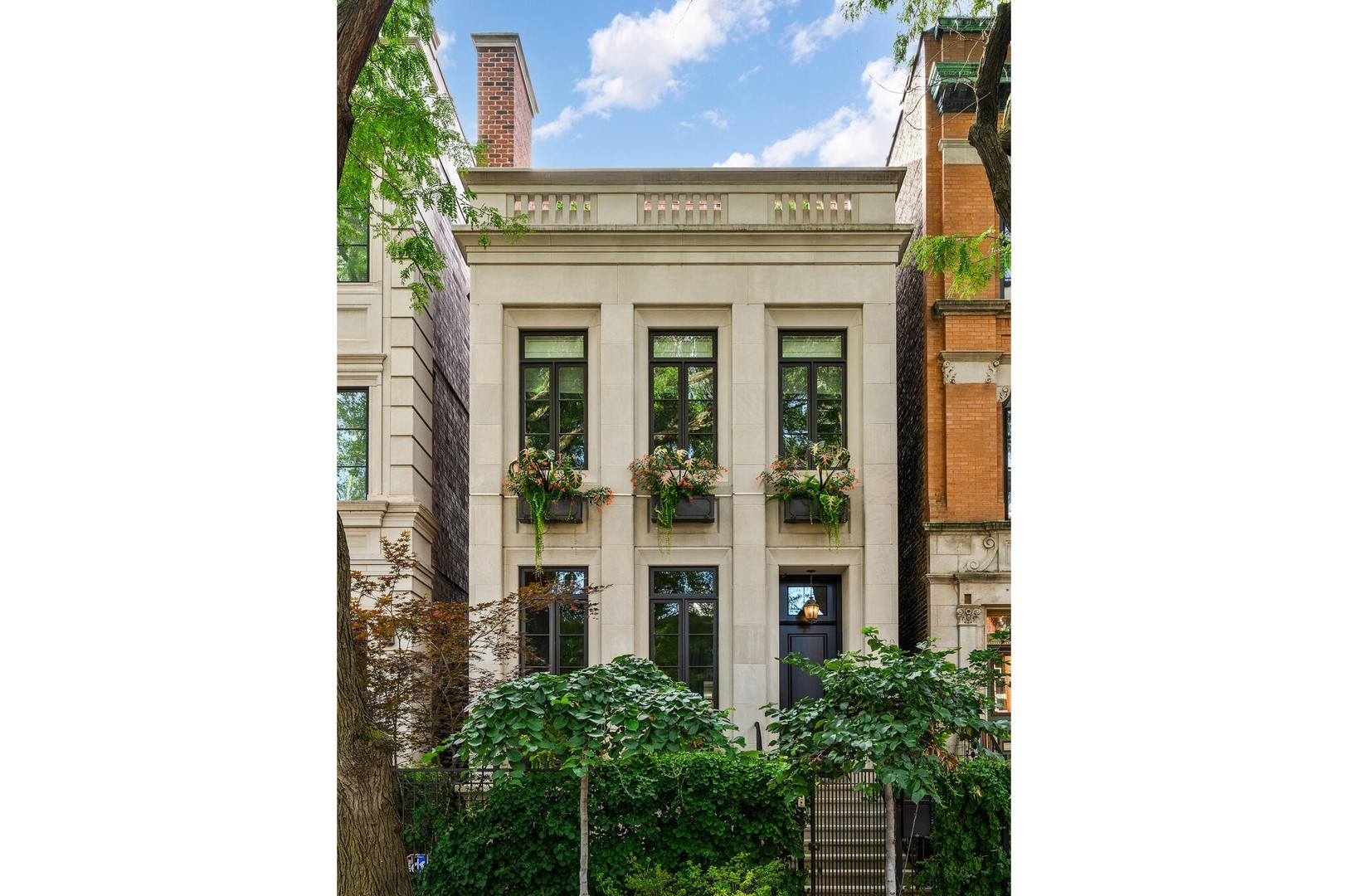1720 N. Mohawk is a showpiece residence situated on one of East Lincoln Park's most coveted streets. Conceived by award-winning LG Development and masterfully designed by Dan Rak, known for his classically contemporary interiors that are precisely tailored and seamlessly executed. This remarkable 6,000 square foot home with six bedrooms achieves the perfect balance of classical architecture, modern comfort, and high design. From the moment you enter, the soaring 12-foot ceilings and grand custom staircase set the tone. The second and third floors feature impressive 10'6" ceilings, while even the lower level offers over 9 feet of ceiling height, ensuring volume and light throughout every level of the home. Every element speaks to exceptional craftsmanship, exquisite trim and millwork, custom built-ins, rift- and quarter-sawn hardwood flooring, elegant hardware, and dramatic fireplaces. Expansive windows frame tree-lined east views, while a proper entry gallery leads to a paneled living room and adjoining dining room anchored by a statement linear chandelier, creating a refined atmosphere for both everyday living and formal entertaining. At the heart of the home is a chef's kitchen designed for both beauty and performance: top-of-the-line cabinetry, professional-grade appliances, an oversized island, and a butler's pantry. The kitchen opens seamlessly to a large eat-in area and a sun-filled family room with coffered ceiling, fireplace, and direct access to private outdoor spaces, including a roof deck with pergola over the 2.5 car garage. The second-floor hosts two ensuite bedrooms and the primary suite, a serene retreat with dual walk-in closets, fireplace with custom built-ins, and a spa bath clad in marble. This sanctuary includes radiant heated floors, polished nickel fixtures, a double vanity, steam shower, and soaking tub. Multiple laundry rooms provide convenience on multiple levels. A skylit staircase brings you to the top level, where a flexible great room with a wet bar opens to a large roof deck with private tree top views. Additional rooms include a private office, extra bedroom, and bath. The oversized windows throughout the home allow an abundance of sunlight. The lower level offers an extraordinary mix of style and function, with a media room with bar, a gym, and a sixth ensuite bedroom. The home was intelligently designed elevator-ready, with stacked closet space available for future installation if desired. The exterior is secured with a 6-foot wrought iron fence, snow melt system, Doorbird video doorbell, irrigation & custom planter boxes. This location cannot be beat, and no detail has been overlooked at 1720 Mohawk-this residence is the epitome of refined Chicago luxury, designed for grand entertaining as well as intimate daily living.