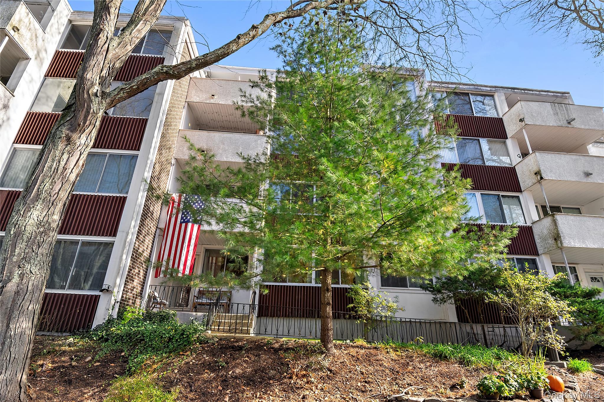 Welcome to 1005 Colony Drive in Hartsdale, a thoughtfully designed two-story condominium that combines modern comfort with practical living. This residence features two bedrooms, two bathrooms, and a well-proportioned layout across approximately 1,506 square feet of living space.The first floor centers around a generous living room filled with natural light and adjoining dining area, providing an open feel ideal for entertaining or everyday gatherings. The kitchen is equipped with white cabinetry, stainless steel appliances including a microwave and refrigerator, and ample counter space for meal preparation. A full bathroom and welcoming foyer complete the first-floor layout.Upstairs, the primary bedroom offers substantial square footage with an attached walk-in closet, while a second bedroom provides flexible space for guests or additional needs. Two full bathrooms serve the second floor, and an in-unit laundry area with washer and dryer eliminates trips to a shared facility. A covered balcony extends the living space outdoors, offering a private retreat with views of surrounding trees and landscaping.Throughout the home, hardwood and parquet flooring create warmth and visual continuity, while ceiling fans provide efficient climate control. Built-in storage and closets maximize functionality without cluttering living spaces. The modern design aesthetic combines clean lines and neutral tones, creating a serene backdrop that welcomes personal style.Hartsdale offers convenient access to major roadways, shopping, dining, and schools. The neighborhood provides a balance of suburban tranquility and accessibility to regional amenities. This condominium presents an excellent opportunity for buyers seeking a move-in-ready home with modern finishes, practical in-unit amenities, and low-maintenance condo living in an established community.