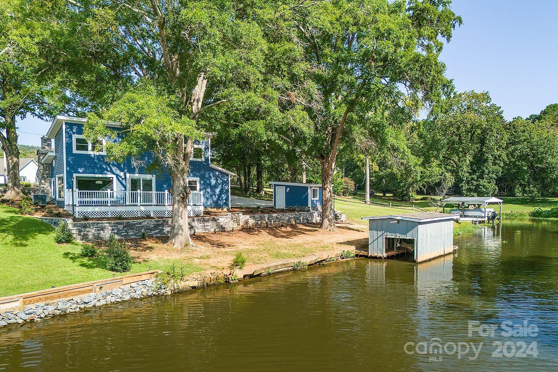 Big price reduction on this attractive updated Lake Tillery cottage with a detached guest facility and a finished storage building.  An additional lot is included making for over 140' waterfront.  This unique property sits in a  quiet cove just off the main channel with Long range views from huge picture windows. Professionally landscaped with ample parking areas. New heat pump, mini-split, and architectural shingles in 2021

There is a cemetery on the additional lot. Do not walk on the pier/boathouse as it appears to be unstable. Stanly County does not have building permits or septic records on file. Advertised as one bedroom per tax card however there are several office and bonus areas, , No representation on fireplace functioning