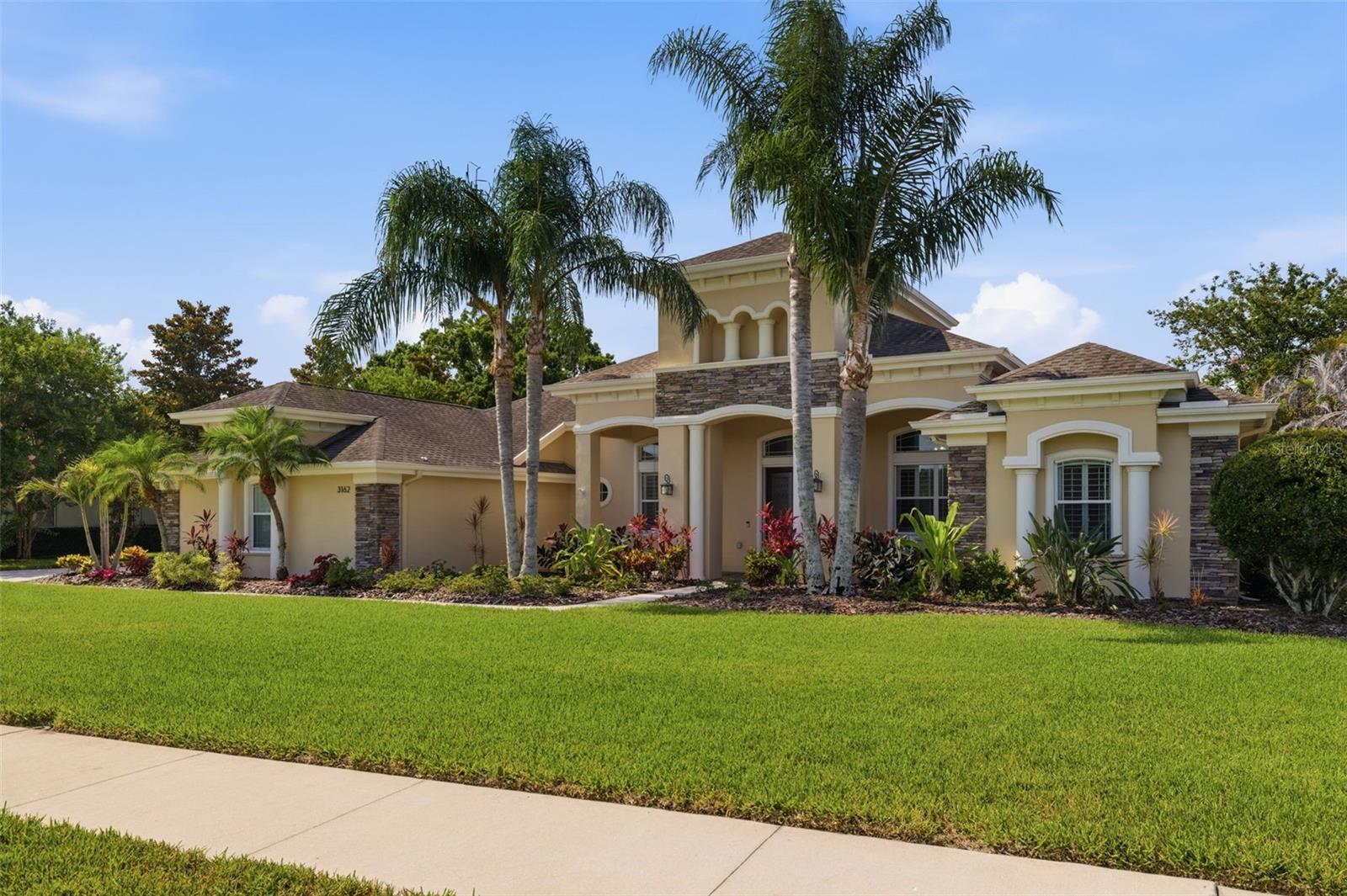 Under contract-accepting backup offers. Peace and privacy await behind the gated community of Foxwood Estates, an exclusive 10-home enclave. Set on nearly an acre, this custom designed home offers over 4,000 square feet of living space creating the privacy and lifestyle that make this neighborhood so sought after.Upon entry, you're immediately greeted by an open-concept layout featuring 4 bedrooms, 2 bonus rooms, a dedicated office, 3 full bathrooms, and 3-car garage, offering multiple gathering spaces for entertaining, working from home, or accommodating guests.At the heart of the home is an expanded custom kitchen. Features include an oversized island, granite countertops, stainless steel appliances, gas cooktop, double ovens, beverage refrigerator, subway tile backsplash, and walk-in pantry with custom shelving The adjacent breakfast nook is nestled beside to a custom mitered corner window that frames seamless views of the pool, pavered patio, large back yard, and a picturesque view of the lake.The family room is anchored by a beautiful floor-to-ceiling unique stone fireplace with gas insert and custom mantel, soaring tray ceilings, built-in window seating with storage, cabinetry, and oversized pocket glass sliders that fully open to the lanai to seamlessly integrate indoor-outdoor living.The primary suite has been customized to create additional space to unwind. This suite features two walk-in closets, a spacious sitting area, and direct access to the outdoor living area. The additional generously sized bedrooms include added square footage, rarely found in today's construction. The dedicated office with added closet space provides flexibility for remote work and storage.The home offers two separate bonus spaces, including a media room with tray ceilings, pocketing glass doors, and natural light, as well as a second bonus room ideal for a playroom or entertainment space. And don't forget the laundry room! It's been upgraded with quartz countertops, a utility sink, and cabinetry for additional storage.Outside, the screened pool area was designed for resort-style Florida living. The custom pool features a beach entry, oversized sun shelf, heated spa, rock waterfall feature, multiple shallow lounging areas, and depths up to six feet, all surrounded by stone pavers and Bose professional grade outdoor speakers. Whether hosting guests or enjoying a quiet afternoon, this outdoor space was built to be enjoyed year round.The nearly one-acre homesite offers exceptional privacy and a front-row seat to the natural beauty of the conservation area and lake, where visitors like deer and other native wildlife frequent. With no front or rear neighbors, and nearly 400 feet of depth from the street to the rear property line, you’ll feel worlds away while remaining close to everyday conveniences.Other notable features include large windows throughout the home, showcasing views of the surrounding property. Enjoying 10-foot ceilings, crown molding, hardwood flooring throughout truly makes this house a home.Built by Deeb Family Homes, Foxwood Estates is known for its generous homesites, quiet streets, and convenient access to top-rated schools, parks, and golf. Crescent Oaks Country Club and Cypress Run Golf Club are just steps away, placing golf and country club amenities at your fingertips. Opportunities in Foxwood Estates are exceptionally limited. Experience the privacy, space, and lifestyle that make this Tarpon Springs' most exclusive offering.