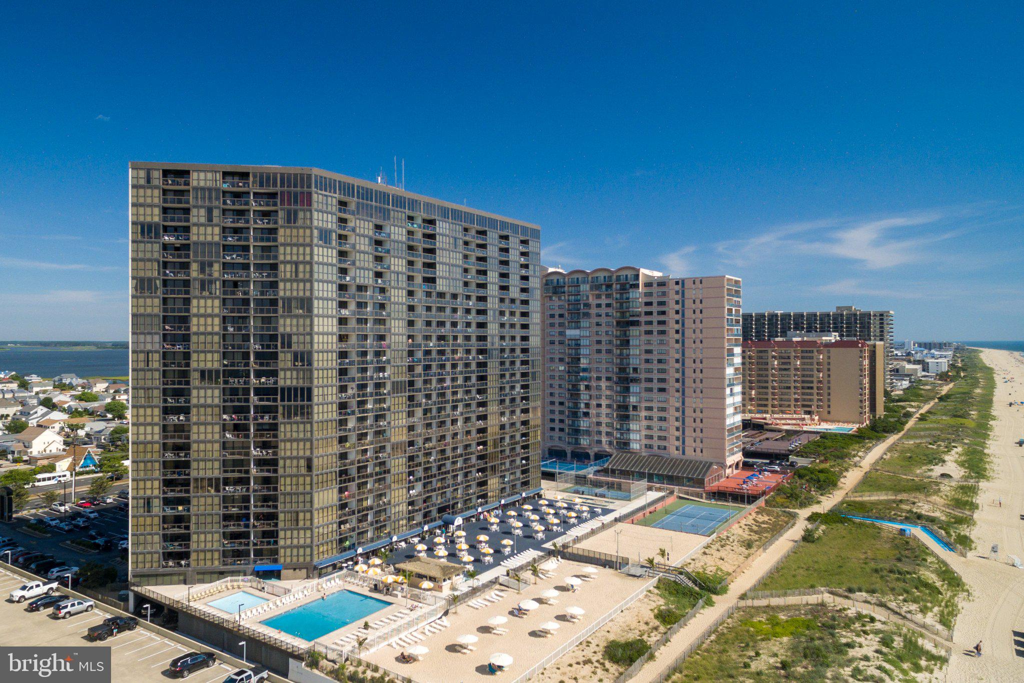 14th Floor Oceanfront| Fully Furnished | Turnkey BeachLife Living at Golden Sands...Ocean-Front condo ideally located in the center of the building, offering beautiful ocean views from the 14th floor and a peaceful bayside view from the bedroom. Enjoy both sunrise over the ocean and sunset skies in the evening.Private balcony spans the full width of the unit which is perfect for relaxing and taking in the views.Open-concept layout with a well-appointed kitchen featuring honey maple cabinetry, wraparound peninsula, and full appliance package, flowing into the main living area with tile flooring throughout.The bedroom offers a tranquil bayside retreat with upgraded plantation-style blinds for privacy and light control. In-unit laundry includes a new washer and dryer (2025), and additional updates include a new hot water tank (2026).Offered fully furnished and truly turnkey. Well-maintained with HVAC covered under a biannual service contract for added peace of mind.Includes a dedicated parking pass and an exterior storage locker, providing added convenience and space for beach gear.Located in Golden Sands, residents enjoy exceptional resort-style amenities including indoor & outdoor pools, private beach access, fitness center, sports courts, on-site dining, and more.