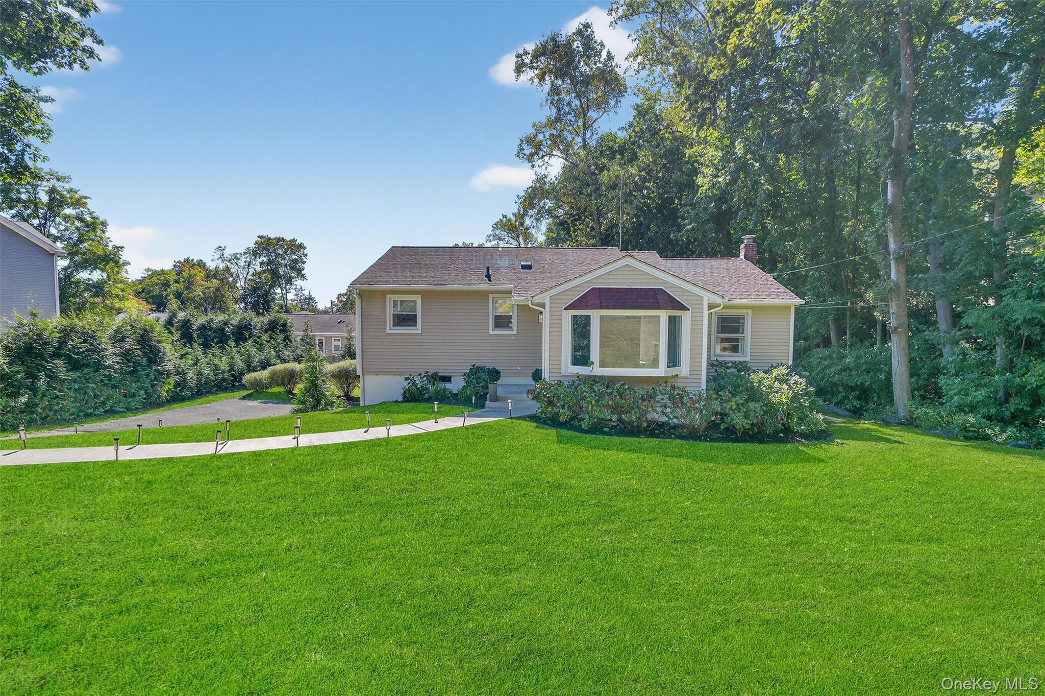 Welcome to this beautifully updated 3-bedroom, 2-bathroom ranch in the heart of Croton Village. The main level features a bright dining area with bay window, spacious living room, primary bedroom, two additional bedrooms, and a stylishly updated full bath. The eat-in kitchen offers a sliding glass door to the deck, perfect for outdoor dining.  The finished lower level provides fantastic additional living space with a large family room, office/den, storage, laundry, and a second updated bathroom. A versatile bonus room with private entry is ideal for a home office or den. Sliding glass doors from the family room lead to a bluestone patio, fire pit area, and private backyard surrounded by arborvitae.  Additional highlights include vinyl siding, new front walkway, new external doors, updated windows in bedrooms, modern light fixtures, smart home features (thermostat and door locks), and a large driveway with ample parking.  Enjoy the convenience of walking to Croton’s charming restaurants and shops, or take advantage of nearby recreation at Silver Lake, Senasqua Park, and Croton Village parks. Just 2.2 miles to the Croton train station and minutes to major highways, this home offers comfort, convenience, and lifestyle.