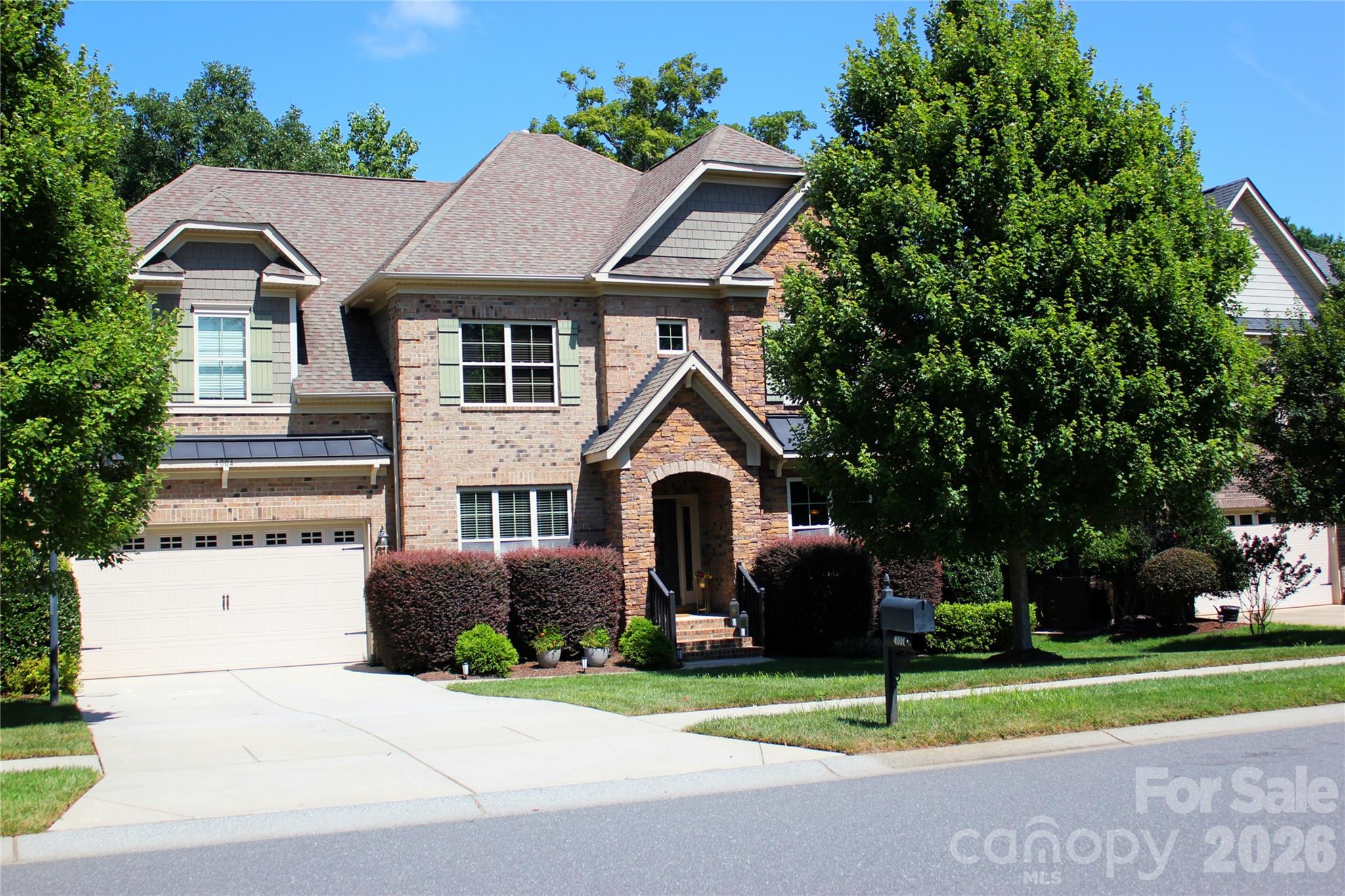 Impressive full-brick home with a beautifully finished walkout basement in desirable Anklin Forrest, just minutes from the shops, dining and small-town charm of downtown Waxhaw. Offering approximately 5,800+ square feet of thoughtfully designed living space across three finished levels, this home combines an elegant presence with the flexibility today’s buyers are looking for. Gracious gathering spaces, substantial moldings, hardwood flooring and architectural details create a polished yet comfortable interior, while the open flow makes the home equally suited for everyday living and large-scale entertaining.At the heart of the home, the gourmet kitchen features freshly painted cabinetry, granite countertops, stainless steel appliances, built-in ovens, a gas cooktop and generous workspace for cooking and gathering. A built-in butler’s pantry provides additional serving and storage space, while the adjoining family room is distinguished by a coffered ceiling and handsome stone fireplace. A formal dining room offers an inviting setting for holidays and special occasions. The main-level guest room with a private full bath is an especially valuable feature, providing comfortable accommodations for visiting family, overnight guests or multigenerational living.Upstairs, the expansive primary suite feels like a private retreat, with an arched opening leading to its own sitting area—ideal for reading, relaxing or creating a quiet morning space. Additional generously sized bedrooms and flexible living areas provide room for everyone to spread out, whether the need is for bedrooms, home offices, hobbies or a second gathering space.The finished walkout basement truly sets this home apart. Designed as a complete entertainment level, it includes a full wet bar, billiard area, dedicated media room for movies and game days, a separate game room/bedroom/flex space, and an additional bedroom with a full bath. This level could easily accommodate extended-stay guests, a private work-from-home arrangement or an impressive recreation retreat. An exceptionally large walk-in storage area—something rarely found in a home with this much finished space—keeps seasonal décor, sporting equipment and household necessities organized and easily accessible.Outdoor living extends from the elevated deck to the lower-level covered patio, both overlooking a peaceful, tree-lined backyard that provides a wonderful sense of privacy. The walkout design creates a natural connection between the basement entertaining spaces and the backyard, making it especially appealing for gatherings. Residents of Anklin Forrest also enjoy a community pool and recreation amenities, all within convenient reach of downtown Waxhaw and highly regarded area schools. With full-brick construction, three finished levels, multiple guest accommodations, abundant recreation space and remarkable storage, this home offers a combination of size, versatility and location that is difficult to duplicate—even within the neighborhood.