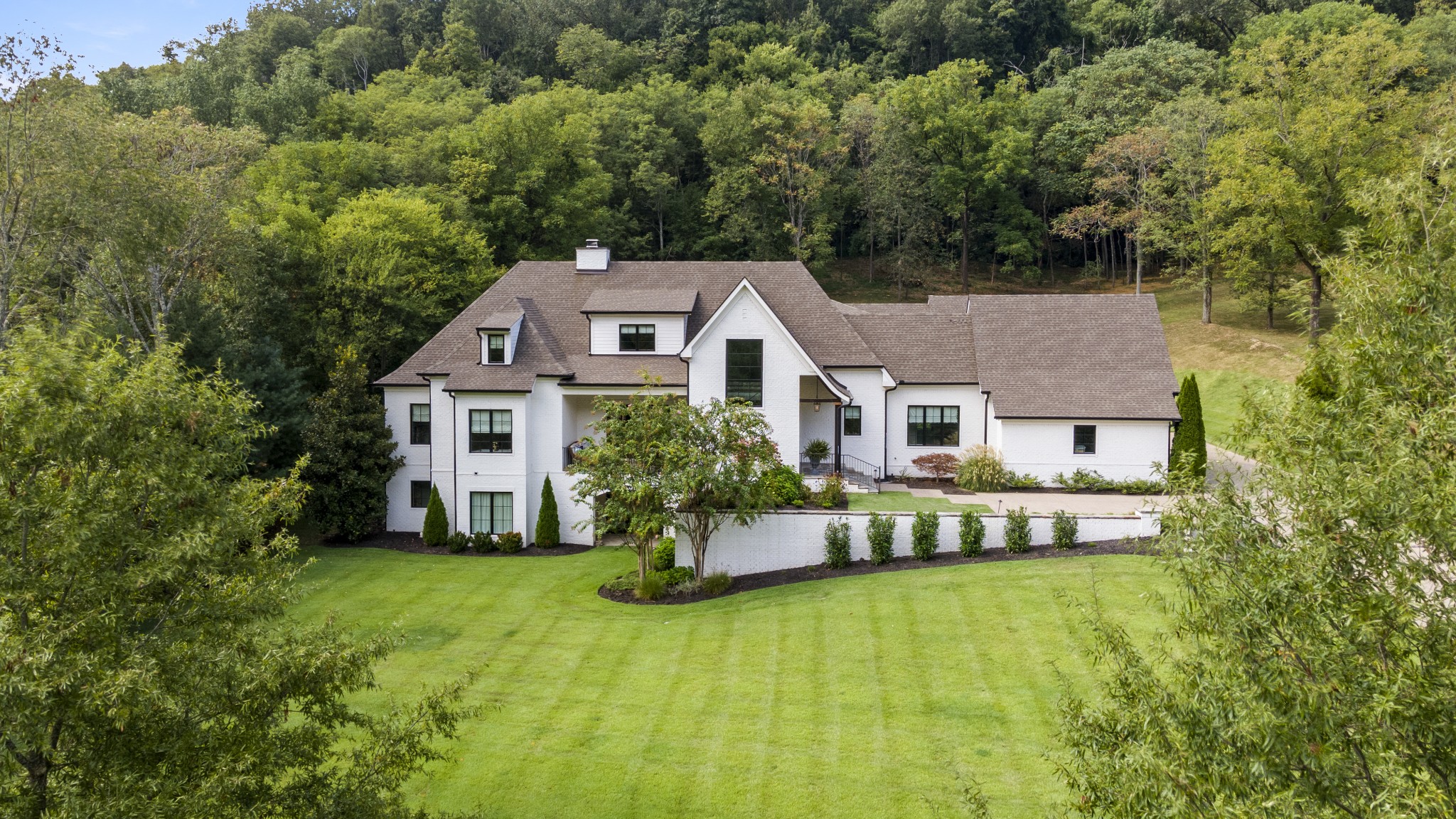Tucked away on over 3 acres in a private gated enclave of only 12 homes, this designer’s personal residence combines timeless craftsmanship with modern luxury. Built by Brentwood Builders and designed by Jamie Pfeffer, one of America’s Top 200 Residential Architects, the home offers soaring ceilings with reclaimed hand-hewn beams, curated designer finishes, and reclaimed hardwood floors throughout.

The gourmet kitchen features custom inset cabinetry, Wolf, Sub-Zero, and Asko appliances, plus a full scullery—ideal for entertaining. Accordion Pella glass doors open to a Rondo-built pool and spa, creating a seamless indoor-outdoor living experience. The primary suite offers direct pool access, dual walk-in closets, and wiring for automated draperies.

The lower level includes a full in-law suite with its own kitchen, a custom bunk room, and a reinforced safe room. Additional highlights include geothermal HVAC, a 4-car garage, whole-house water conditioning, fire suppression system, and Rainbird smart irrigation.

This estate offers privacy, convenience to Cool Springs, Franklin, and Brentwood, and an unmatched level of design and detail.
