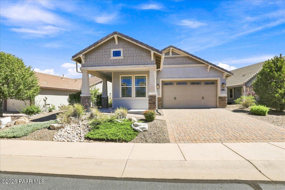 Newer Craftsman-style home built in 2018 and ideally located in the desirable, centrally located Prescott Lakes Community. Offered to the market for the first time, this clean and move-in ready single-level home combines thoughtful design, energy efficiency, stylish updates, and easy-care living. Step through the front door into an inviting open concept floor plan filled with abundant natural light. The beautiful modern kitchen is the heart of the home, featuring an extended island with seating for four, quartz countertops, ample dovetail cabinetry, stylish subway tile backsplash, and a large walk-in pantry. The dining area flows seamlessly into the living room, creating a spacious great room setting that is perfect for everyday living and entertaining. The desirable split bedroom floor plan provides privacy, with the spacious primary suite positioned just off the living room. The suite features a custom barn door and a generous walk-in closet. The second bedroom, conveniently located toward the front of the home near the full guest bathroom makes an ideal guest retreat. The third bedroom features double solid French doors and offers exceptional flexibility as an office, den, or additional living space. Recent improvements add to the home's turnkey appeal, including high-quality, durable waterproof luxury vinyl plank (LVP) flooring throughout, fresh new interior paint, and a recently added stylish kitchen backsplash. The laundry room includes cabinetry plus a dedicated storage area with potential to add shelving for even more organization. The upgraded two car garage features a deeper extension, providing additional room for hobbies or storage along both sides. Outside, enjoy low maintenance front and backyard landscaping served by drip irrigation. The fully fenced backyard is especially pet friendly, with the expansive artificial turf and an extended covered paver patio ideal for relaxing, entertaining, or enjoying Prescott's beautiful outdoor lifestyle. Location is a standout feature, with this home just minutes from Historic Downtown Prescott's Courthouse Square, Costco, Yavapai Regional Medical Center, the VA Medical Center, Walmart, Safeway, Trader Joe's, Fry's, shopping, dining, and everyday conveniences. Within walking distance is the exclusive, members-only Prescott Lakes Golf and Country Club, offering private golf, indoor and outdoor pools, tennis, pickleball, bocce ball courts, a fitness center, exercise classes, social clubs, a restaurant, and numerous community events. Outdoor enthusiasts will appreciate being just minutes from Willow Lake and Watson Lake, two of Prescott's premier recreational destinations. Come experience the active and social lifestyle, quality home features, exceptional clubhouse amenities, and convenient location this charming Astoria neighborhood home within Prescott Lakes has to offer. This is Prescott Lakes living at its best!