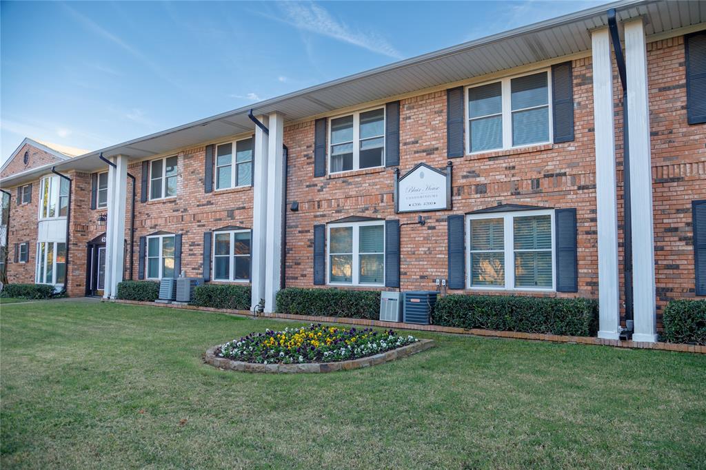 View of front facade featuring a front lawn and brick siding