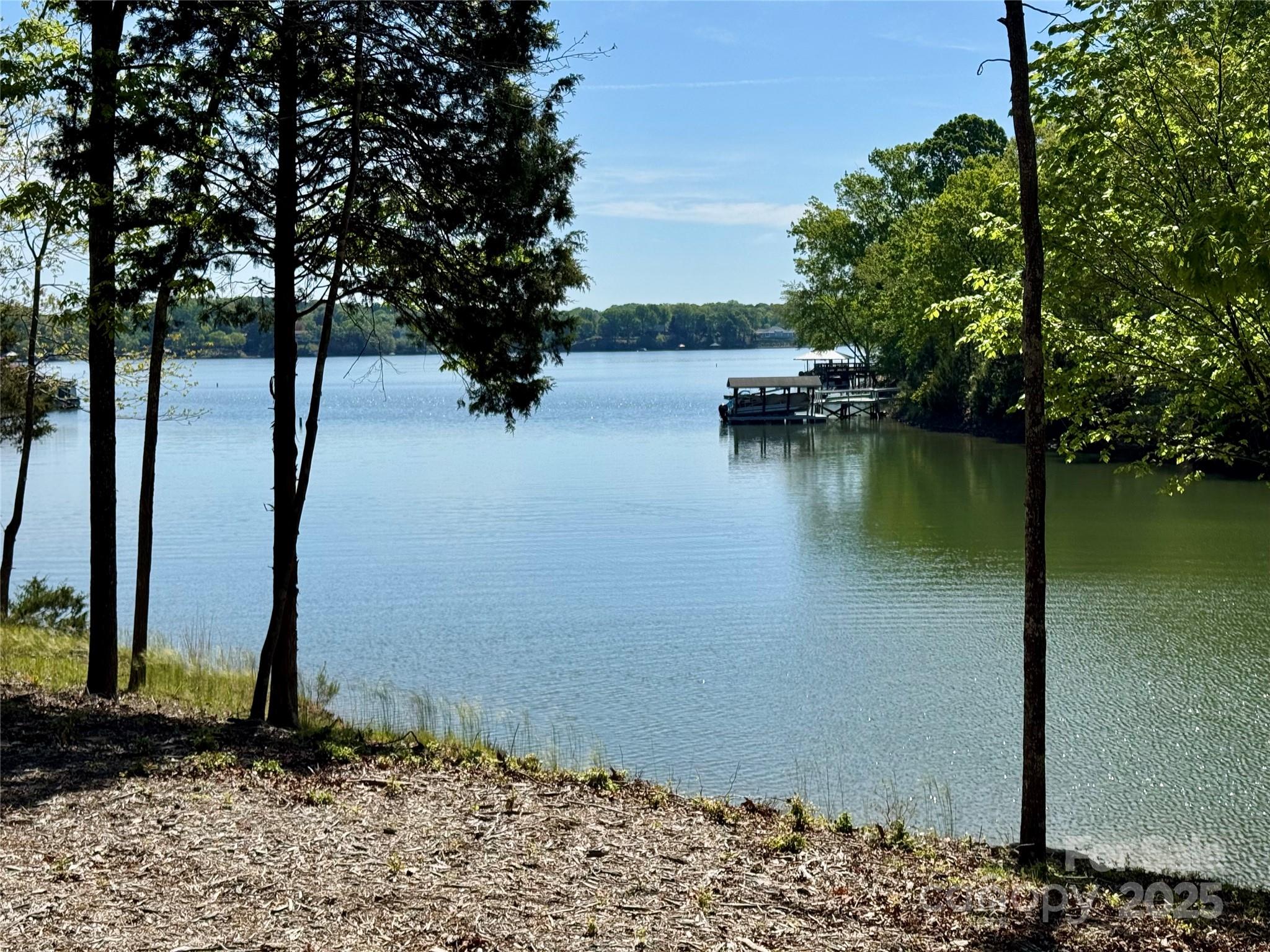 RARE opportunity to build your waterfront dream home on this pristine 5.25 acre lot with over 357ft of water frontage on Lake Wylie!! Located just off the main channel with deep water, this is the perfect place to call home. The lot is mostly level with a gentle slope towards the water, and there are several wonderful places to position a home to take advantage of the stunning lake views. The seller has obtained dock permit approval and there is a nice area for a beach as well. All of the surrounding lots are 5 acres or greater, so you will have complete privacy and plenty of space. The community is less than 10 miles from Lake Wylie or Rock Hill, and only 25 miles from the Charlotte Airport. The seller has obtained a septic permit for a 5 bedroom home. NO HOA, no CCR's and no restrictions. Clover Schools and low Lake Wylie Taxes!!