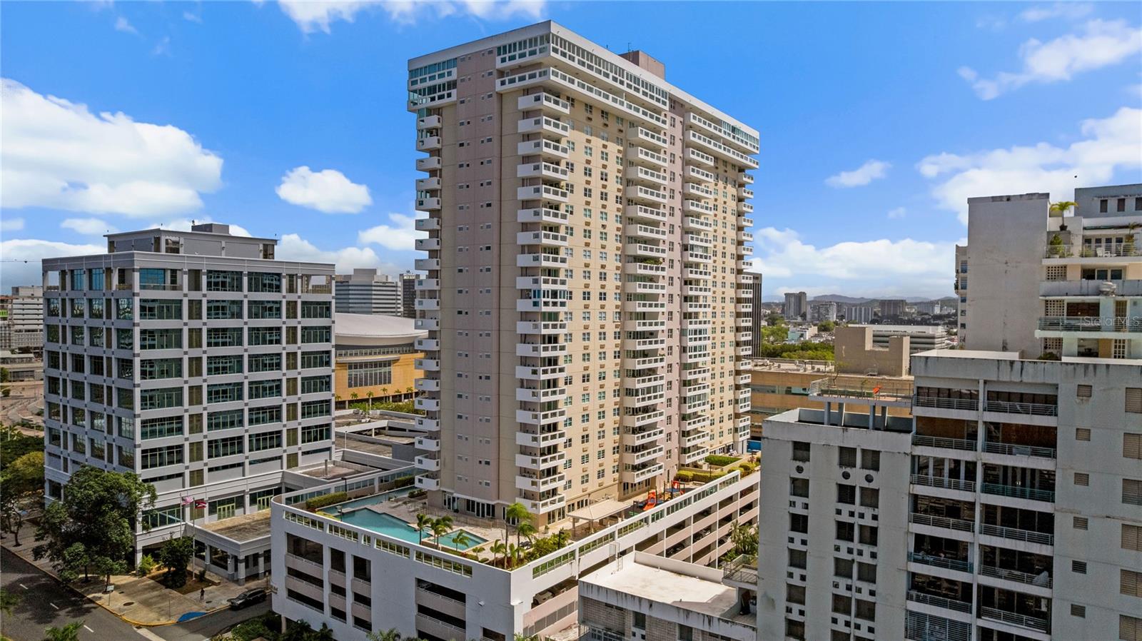 Experience elevated metropolitan living at Coliseum Tower Residences, an exclusive condominium perfectly situated in the vibrant heart of Hato Rey, steps from the iconic Coliseo de Puerto Rico Jose Miguel Agrelot ("El Choliseo"), one of the Caribbean's premier entertainment venues. This dynamic and centrally located neighborhood places residents at the center of San Juan's financial district, La Milla de Oro, while remaining just minutes from premier shopping and entertainment at Plaza Las Americas, as well as major retailers and cultural venues such as Popular Center Fine Arts. Located on the 8th floor, this beautifully designed 2-bedroom, 2-bathroom residence offers approximately 1,584 square feet of thoughtfully planned living space. The home features sleek contemporary finishes and a luminous open-concept layout that seamlessly connects the living, dining, and kitchen areas, creating an inviting atmosphere ideal for both everyday living and entertaining. Expansive windows and a private balcony frame captivating city views, while the well-proportioned bedrooms provide comfort and privacy within this sophisticated urban retreat. The residence also includes two deeded parking spaces, adding exceptional value and convenience. Residents of Coliseum Tower enjoy a boutique condominium lifestyle complemented by a full array of resort-style amenities. The building offers 24/7 guarded security, outstanding recreational facilities including a fully equipped professional gym, and an entertainment and activity room. Outdoor amenities include three swimming pools: a rectangular pool, a children's pool, and a dedicated lap pool for avid swimmers, as well as a hot tub for relaxation. The property also features two barbecue areas, a children's playground, and a wrap-around walking path ideal for enjoying the outdoors while taking in sweeping views of the surrounding cityscape. Perfectly positioned in the center of Metro San Juan, the residence offers convenient access to the Tren Urbano transit system, the financial district, major highways, fine dining, shopping, and the vibrant nightlife that defines the metropolitan lifestyle of San Juan. Combining location, lifestyle, and convenience, this exceptional condominium presents a rare opportunity to own in one of the capital's most dynamic and connected neighborhoods.