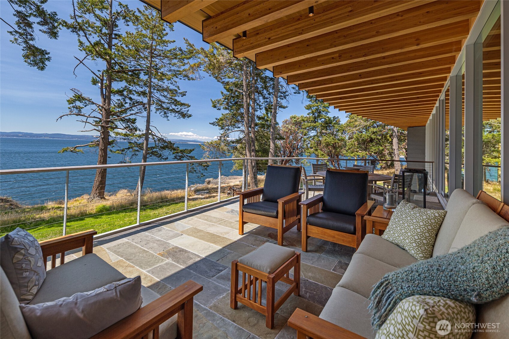 A rare architectural masterpiece on San Juan Island's coveted west side, this iconic Bohlin Cywinski Jackson-designed estate showcases intentional design and refined craftsmanship across nearly 10,000 sf of conditioned space. Privately sited on 6 acres with 400' of waterfront, the recently completed residence blends soaring spaces, floor-to-ceiling windows, and rich natural materials for a grounded sense of luxury. A chef's kitchen, elegant great room, and serene primary suite anchor the main level, while below offers guests quarters, a wine cellar, and hobby space. The estate includes a workshop/garage, a fully equipped greenhouse, and fenced gardens. Enjoy views of Haro Strait, the Olympics, and visits from whales and wildlife.