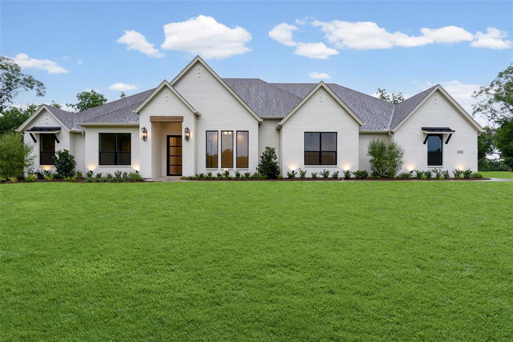 Showcase of Homes 2nd place winner! This stunning Modified Cape May Signature Series by Couto Homes sits on over 1.5 acres in Pecan Plantation. It offers 4 bedrooms, 3.5 bathrooms, a study, game room, 3-car garage, and 3,374 square feet of thoughtfully designed living space. The all-brick exterior makes a lasting first impression, featuring brick entry columns, 8 ft iron door, architectural window awnings with steel brackets, and coach lighting at both the entry and garage. White oak accents and wood beams bring warmth to the main living areas, paired with slim shaker cabinetry and modern brass details for a clean, updated look. The kitchen is anchored by a double island with a quartz apron-front sink and full quartz backsplash, along with a dedicated coffee nook. The fireplace in the living room adds a focal point and cozy ambiance to the open-concept main area. LED under-cabinet lighting and a spacious walk-in pantry round out the kitchen's functionality. The primary suite is a true retreat, offering a generous bedroom, a spa-like bath with dual vanities and custom herringbone tile flooring, and TWO separate walk-in closets. Three additional bedrooms with one having a private ensuite — ideal for guests or multigenerational living. A dedicated pool bath and a 443 sq ft covered rear porch make outdoor entertaining effortless. Engineered wood flooring carries a cohesive feel throughout the home, while energy-efficient windows keep comfort high year-round. The property is equipped with a 3 car epoxy floored garage, with a 20,000 sq ft landscape package including grass, planting beds, and a finished driveway. Pecan Plantation is a gated community with 24-7 on-site security. Amenities include swimming pools, tennis courts, dining, golf courses, hardware store, car wash, grocery shopping and more within the gates.