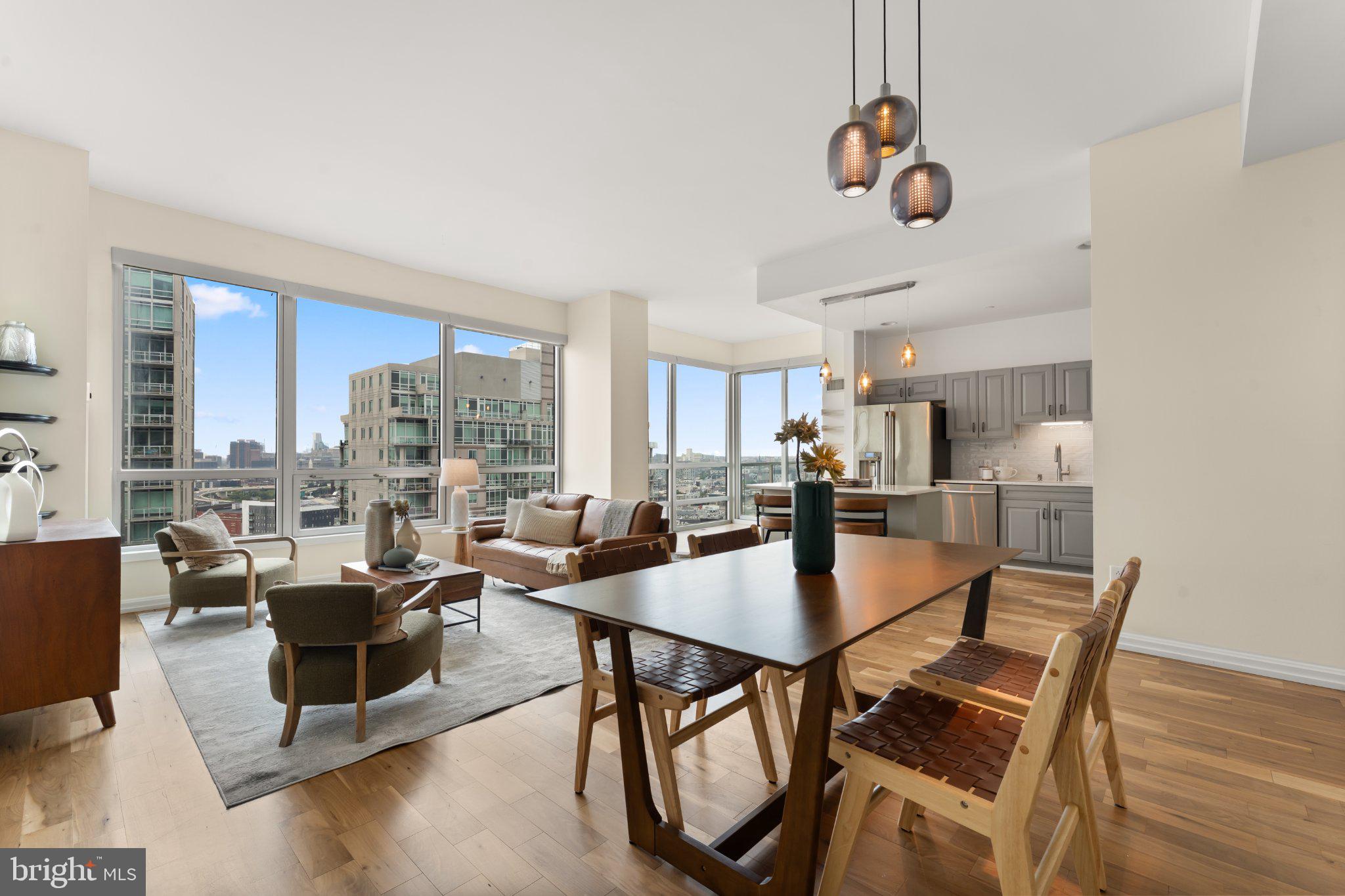 Perched high above the Delaware River on the 20th floor of Waterfront Square’s Regatta tower, Residence R2003 is a beautifully presented corner home where light, space and some of Philadelphia’s most impressive views take center stage.Spanning approximately 1,565 square feet, this spacious 2-bedroom, 2.5-bath residence offers a scale rarely found in newer construction. The thoughtfully designed floor plan features generously sized rooms, excellent separation between the bedroom suites, and walls of floor-to-ceiling glass that flood the home with natural light throughout the day. Its balcony exposure frames sweeping views of the Delaware River, Benjamin Franklin Bridge and Center City skyline, an ever-changing backdrop that is just as striking after dark as it is during the day.The main living space feels open and expansive, with beautifully recently refinished wood floors, abundant glass and plenty of room to create distinct living, dining and entertaining areas without sacrificing flow. Step outside to the private balcony for fresh air and an unobstructed perspective over the city and waterfront, or simply enjoy the view from nearly every major living space inside the home.The kitchen has been thoughtfully updated and opens directly into the living area, creating an easy layout for both everyday living and entertaining. Both bedrooms are exceptionally well proportioned and positioned on opposite sides of the residence for privacy. Each offers its own en-suite bath and substantial closet space, while the primary suite takes full advantage of the home's dramatic outlook. Updated baths, abundant storage and a convenient additional powder room further elevate the functionality of the floor plan.Meticulously maintained and presented in immaculate condition, R2003 offers the increasingly rare opportunity to move directly into a substantial, high-floor waterfront residence without taking on a major renovation.Waterfront Square itself offers a resort-like setting on approximately 9.5 gated acres along the Delaware River, with 24-hour security and concierge services, indoor swimming pool, fitness and spa facilities, sauna and steam rooms, landscaped riverfront grounds, walking paths, dog parks, putting green, on-site parking and direct access to the waterfront. Yet despite the private setting, the community sits moments from Northern Liberties, Fishtown, Old City and Center City, with convenient access to I-95 and the region's major bridges.The location is also positioned along one of Philadelphia's most actively evolving corridors. The broader Central Delaware Waterfront continues to see significant public and private investment, including the expanding Delaware River Trail, new parks and connections, redevelopment initiatives and the transformational 11.5-acre Penn's Landing Park now under construction farther south along the waterfront. Together, these projects are part of a long-term effort to better connect Philadelphia's neighborhoods to the river and create a more continuous, active waterfront.For buyers who want the ease and amenities of condominium living without giving up space, outdoor access, natural light or a truly memorable view, R2003 stands apart.