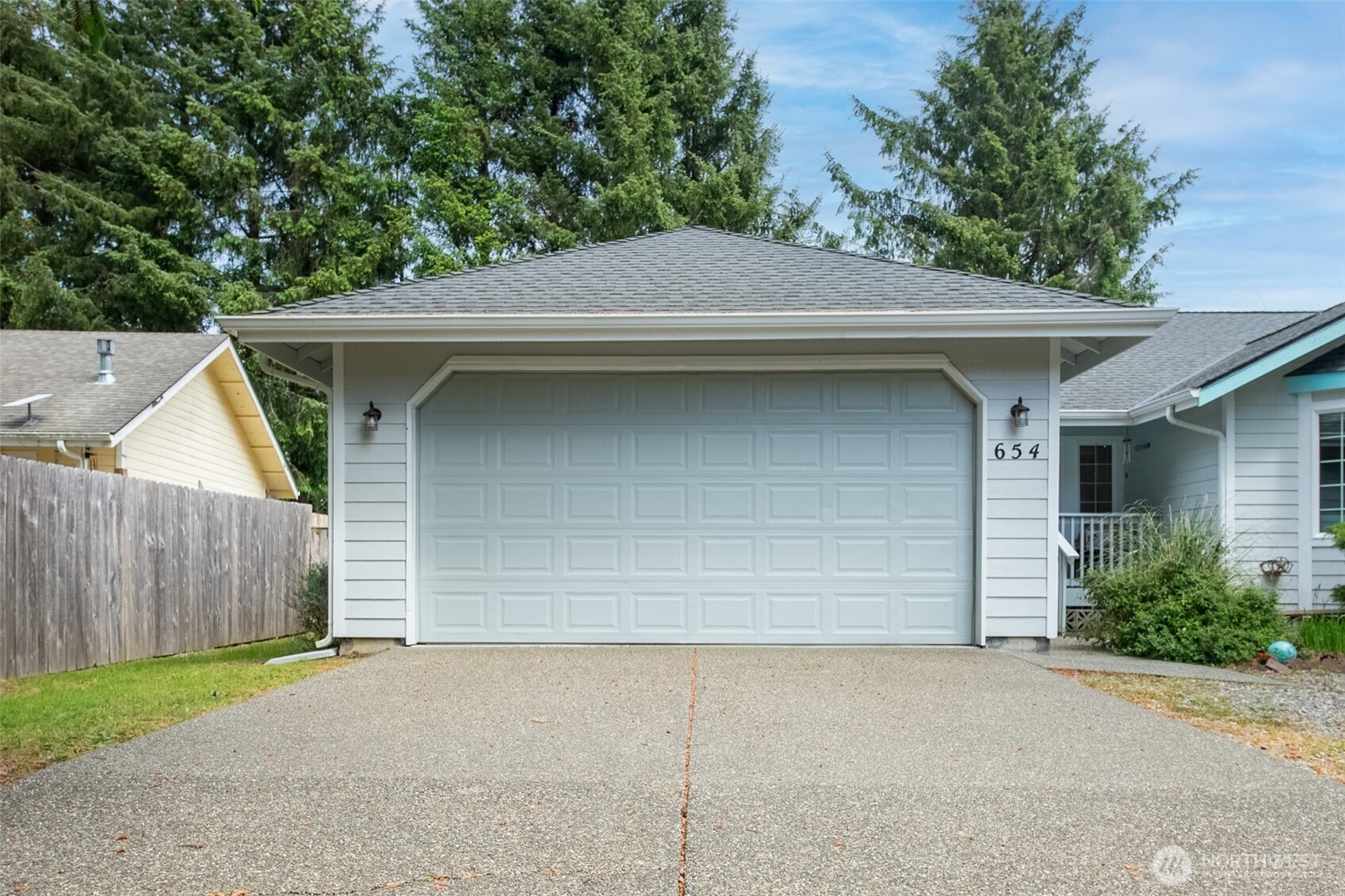 This beautiful single-level Ocean Shores home checks all the boxes. Situated on a large corner lot close to Duck Lake and shopping, it’s tucked into a quiet neighborhood that offers the perfect balance of privacy and convenience. Inside, you’ll find 3 comfortable bedrooms and 2 full bathrooms, designed for easy everyday living and effortless entertaining. The spacious open living room with vaulted ceilings creates an airy, inviting feel and flows seamlessly into the dining area and expansive kitchen—complete with abundant counter space, plenty of cabinetry, and a kitchen pantry for extra storage. The primary suite offers a generous closet and a private full bath, creating a comfortable retreat. Outside, the property is surrounded by trees, offering a peaceful natural setting while still providing sunny spots ideal for gardening. The front yard features mature landscaping, while a huge two-car garage provides plenty of space for vehicles, storage, and projects. RV parking is located in the back, conveniently set near the hot tub area. Out back, enjoy a fully fenced yard with excellent privacy, a greenhouse for gardening enthusiasts, and a large patio—perfect for summer BBQs and outdoor entertaining.