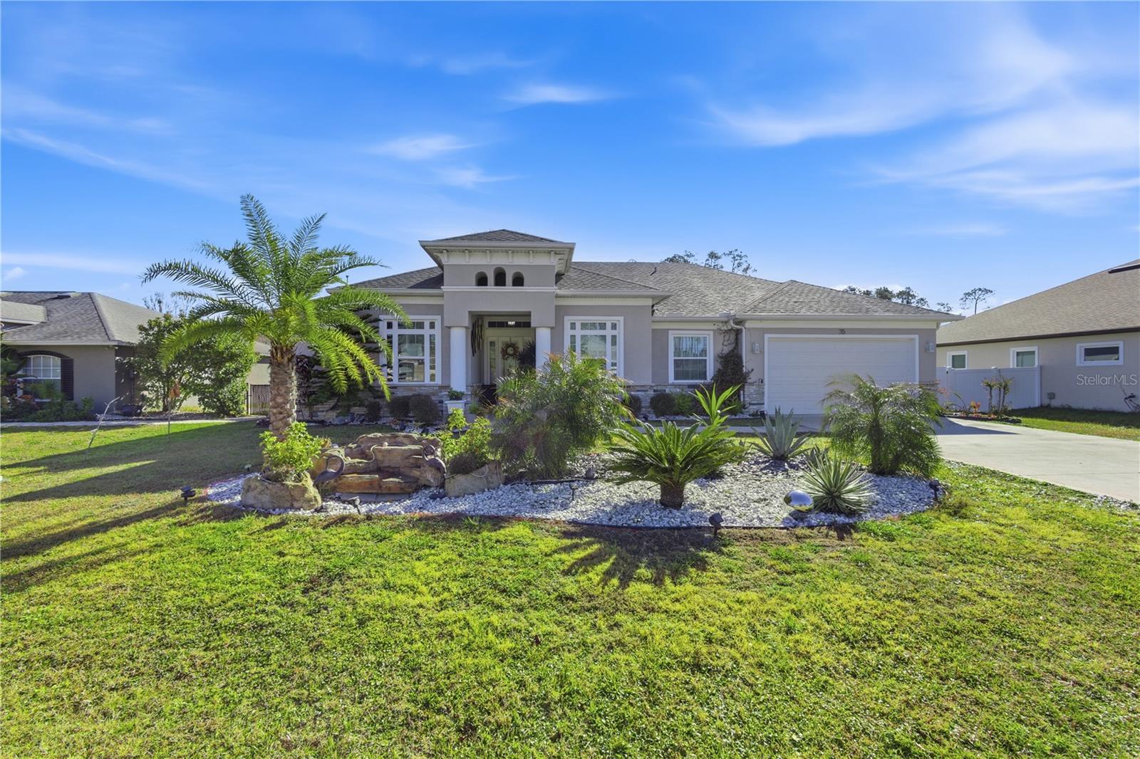 Welcome to this nearly new, 2022-built heated pool home, offering a fully fenced backyard and a 3-car tandem garage (two-car frontage with an extra-deep bay ideal for a third vehicle, boat, or additional storage). Step inside to a bright, open layout highlighted by soaring tray ceilings and a spacious, airy feel throughout. The open-concept floor plan is perfect for entertaining, featuring a beautiful light-filled kitchen with a large center island and island seating, ideal for gathering with family and friends. The private primary suite showcases a tray ceiling and a luxurious en-suite bath with his-and-hers vanities, a soaking garden tub, a large walk-in shower, and generous walk-in closets. The split-bedroom layout provides privacy, with the second and third bedrooms offering high ceilings and sharing a spacious second full bath. Step outside to your own private retreat—an impressive in-ground heated pool with a huge screened lanai, accented by elegant travertine tile flooring. The expansive covered area is perfect for year-round outdoor living and entertaining, all within a beautifully landscaped and private backyard. Located in one of Palm Coast’s most desirable NO-HOA communities with no rental restrictions, this home offers exceptional flexibility for primary residence, second home, or investment use. Enjoy proximity to miles of biking and hiking trails, the Palm Coast Tennis & Pickleball Center, and just minutes to the beach. Welcome home to your own private oasis.--
