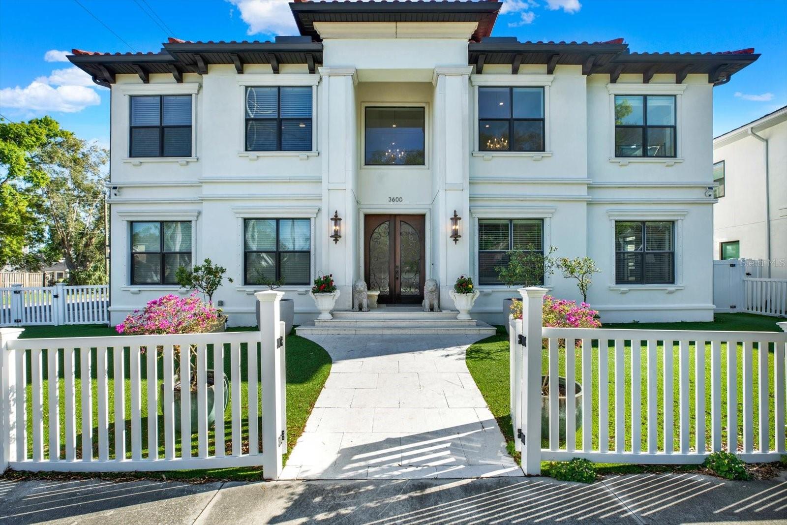 Welcome to 3600 West San Luis Street, an architecturally refined and custom-built residence, offering an elevated blend of design, comfort, and effortless indoor-outdoor living in the highly sought-after Plant High School district. A grand entry begins with dramatic double doors that open to an impressive foyer, where a sweeping spiral staircase is complemented by three chandeliers—creating a striking and sophisticated first impression. Thoughtfully designed with an emphasis on flow and balance, the home offers a seamless transition between spaces, enhancing both everyday living and entertaining.The true centerpiece of the home is the wall of sliding glass pocket doors that collapse into the walls—blurring the line between indoors and out. This signature feature transforms the living space, inviting in natural light and expanding the home’s footprint to create an exceptional indoor-outdoor lifestyle experience.Outdoors, a private retreat awaits. The heated saltwater pool and spa are set within an enclosed lanai, complemented by an outdoor kitchen—perfect for hosting or relaxing year-round. The grounds are wrapped in 360-degree turf for a refined, low-maintenance aesthetic, while the absence of large trees allows for effortless upkeep. A durable tiled roof adds both beauty and longevity.Inside, the kitchen showcases rich wood cabinetry, wine refrigerators, and quality finishes that reflect attention to detail throughout the home. Additional features include a storage shed and a gun safe for added convenience.Positioned approximately 16 feet above sea level, the property is high and dry—offering both peace of mind and long-term value.This is a truly custom-built residence where thoughtful design meets elevated living in one of Tampa’s most desirable locations.