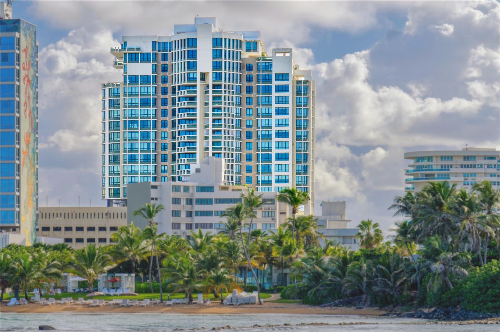 Residence 901 at Caribe Plaza offers refined living in one of San Juan’s most prestigious full-service residential towers, known for its exceptional service. This elegant 9th-floor residence features bright, open living spaces framed by expansive windows showcasing beautiful views of the Atlantic Ocean, Old San Juan, and the city skyline. A private elevator opens directly into the residence, creating an elevated sense of exclusivity and privacy. Thoughtfully designed for both comfort and sophistication, the home offers generous living and entertaining spaces, including formal living and dining rooms, a family room, and a private balcony that captures the surrounding views. The well-appointed kitchen is complemented by spacious interiors and seamless flow throughout. The primary suite serves as a peaceful retreat, featuring a generous walk-in closet and a spacious bath. Two additional ocean-view en-suite bedrooms provide comfort and privacy, complemented by separate den with an en-suite bathroom. Residents enjoy an elevated suite of amenities, including 24-hour security, concierge services, backup power generator, water reserve systems and three covered parking spaces per residence for complete peace of mind. A newly redesigned swimming pool and state-of-the-art fitness center are currently underway and set to unveil next year. Ideally located between Condado and Old San Juan, Caribe Plaza offers effortless access to San Juan’s finest dining, shopping, beaches, and cultural landmarks. Within close proximity to Miramar and Hato Rey, the location blends urban convenience, scenic ocean views, and an exceptional lifestyle.