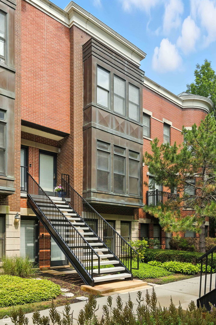 Discover the Modern Classic Home in University Village. Nestled in a quiet garden courtyard, this south-facing spacious 3 bedroom / 2.5 bath townhome is bright throughout filled with natural light all three-levels. This stunning home is newly designed to blend timeless and conform to city oasis living. Inside, the first floor has versatile functionality, to be a family room, a third-bedroom or perfect for working from home office.  The second floor is an open floorplan for oversized living & dining space with wood burning fireplace, NEW light fixtures, NEW finishes hardwood (nature red oak) floor, NEW paints, tall windows overlooking the garden & green. The generously appointed kitchen comes with NEW sleek quartz countertop, NEW seamless-look backsplash, all stainless-steel appliances (NEW range cooktop), NEW cabinet paints, and it's spacious for a smaller eat-in kitchen table. Freshly painted walls on the entire floor. A powder room just off the kitchen is perfect for guest use.  From here conveniently walking out to the large balcony great space for relaxation, BBQ & entertaining.   The third level features a primary bedroom with NEW lux carpet, NEW light fixture and large wall-in closet space. The master bath comes with a soaking tub, NEW sleek double vanity and NEW mirrors and lighting. Second bedroom features NEW carpet, NEW painted walls and lighting. A newer pair of laundry adds everyday convenience.   Walk up this floor to enjoy panoramic city skyline views from the private rooftop deck, ideal for entertaining or simply unwinding in your own urban oasis.  With NEW garage walls & new door, the  private 2-car garage offers secure parking and extra storage. University Village is situated near Little Italy/UIC, Pilsen, and the West and South Loop, providing access to vibrant surroundings. The community offers numerous parks, athletic fields, playgrounds, pet areas, and scenic grounds to explore. Close to expressways, CTA, and Metra, with Lake Shore Drive and the museum campus just a seven-minute drive away.