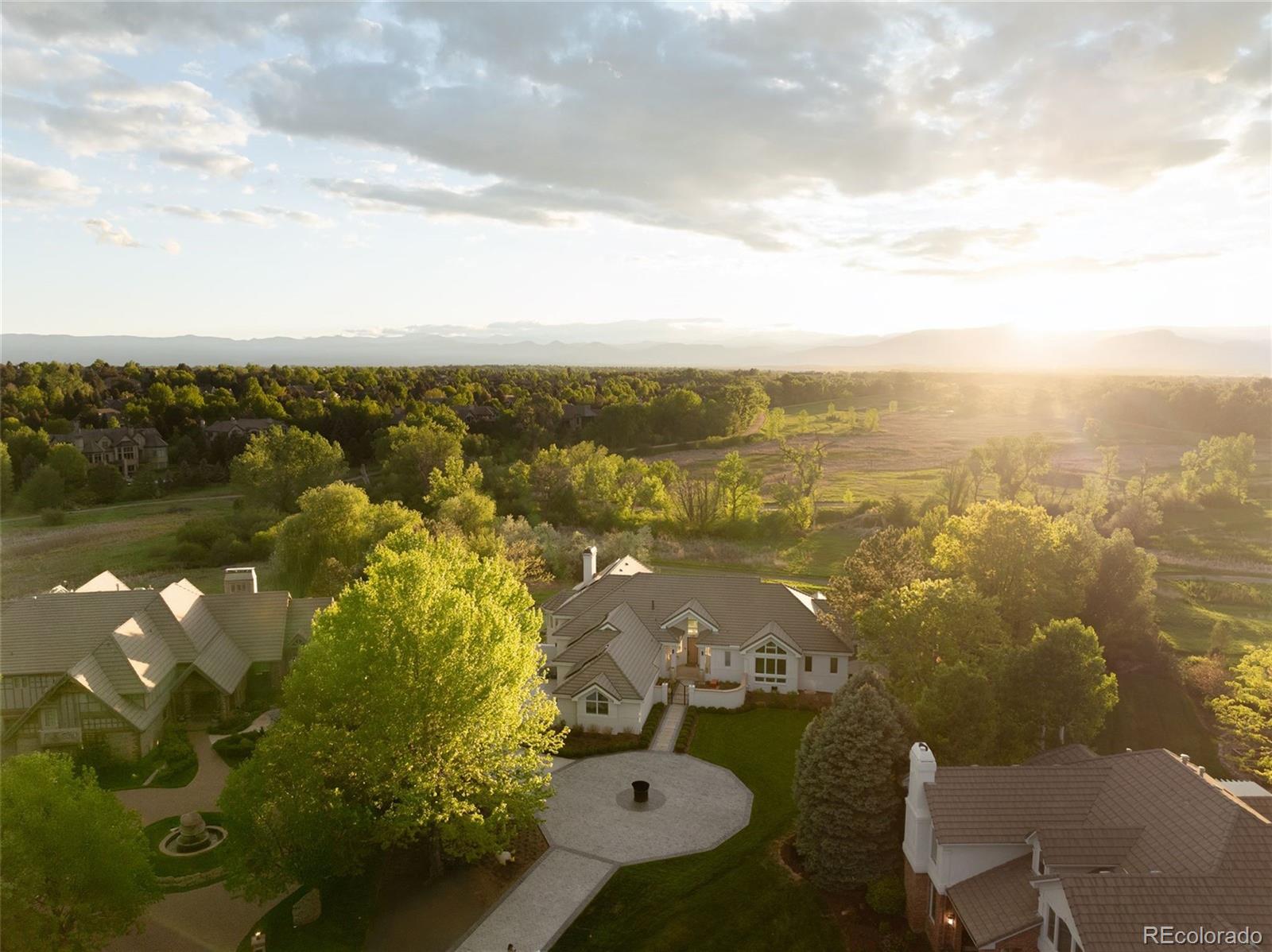 This exceptional modern estate has been meticulously renovated and reimagined with a level of craftsmanship and design that places it in a class of its own. Set against the backdrop of the Marjorie Perry Nature Preserve and High Line Canal in prestigious Greenwood Village—and framed by sweeping mountain views—this is a true Colorado luxury residence of remarkable sophistication. Inside, the home showcases impeccable master carpentry, including a visionary walnut staircase, worthy of Architectural Digest, and a floor to ceiling cabinet wall with Japanese dovetails that functions as both a separation of entertainment space, and an art installation. The primary suite features a masterfully re-designed closet and dressing area that was doubled in size, and flawlessly executed with custom walnut cabinetry and elevated ceilings, creating a discriminating and luxurious space to experience chic couture, and high-end vogue fashions. Nearly every room is bathed in natural light through expansive glass walls that highlight both the mountain vistas and the refined modern design details throughout the home. Outdoors, the estate’s grounds have been fully design integrated into the natural landscape with no detail overlooked. Highlights include a professional-grade putting green, a serene Japanese river rock installation with hand-selected quarry stone, and striking architectural sculptures that frame the Rocky Mountains. Every major system has been upgraded to the highest standard, seamlessly integrated with smart home technology that includes 40 solar panels, 3 Tesla Power Walls, Security, and EV Chargers. This residence is a true work of art that manages to be both refined and inviting, exquisite and charming, livable and luxurious. This one must be experienced to be appreciated.