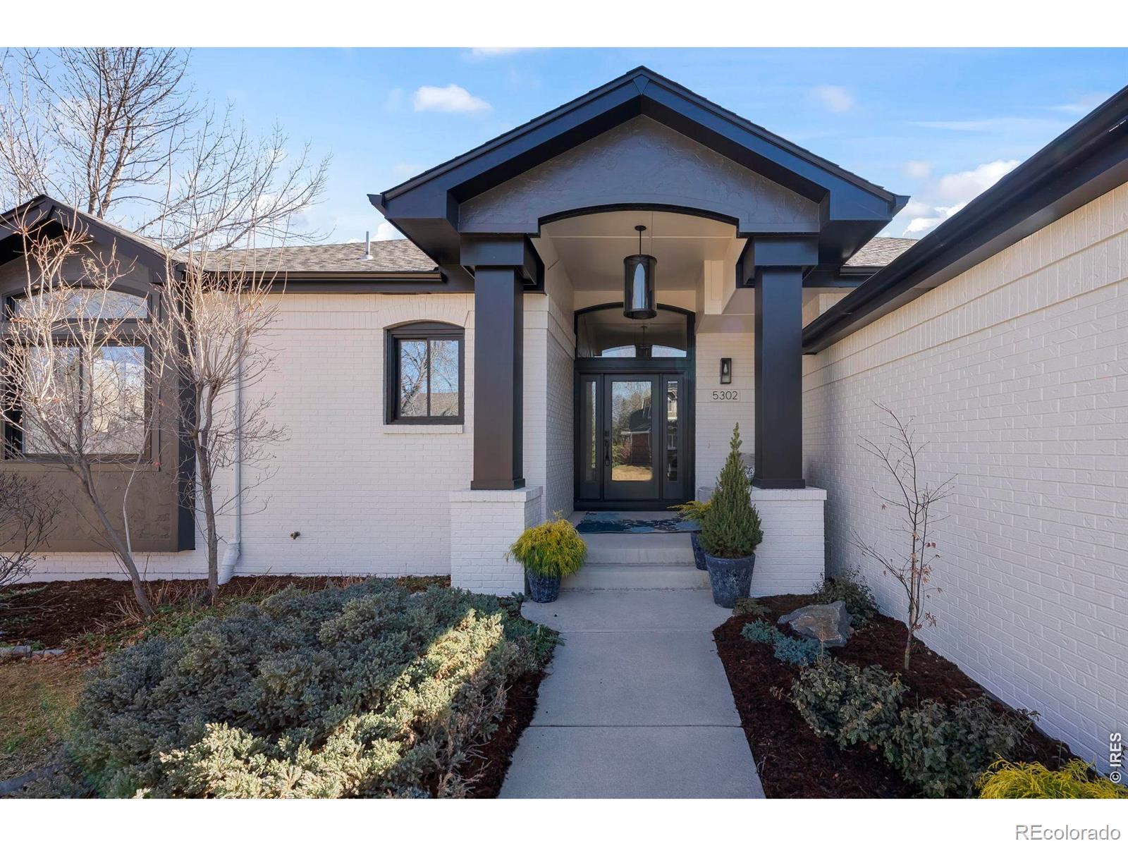This stunning ranch-style home has been completely remodeled and renovated from top to bottom, offering striking modern curb appeal and a desirable 3-car side-load garage. Step inside to an elevated lifestyle with an expansive open floor plan highlighted by soaring ceilings, wide-plank white oak flooring, designer lighting, and generously sized rooms throughout. Enjoy 3,000 SQFT of main-level living space showcasing exceptional style and modern finishes. The high-end chef's kitchen flows seamlessly into the impressive great room-the true heart of the home-featuring an elegant fireplace and the perfect setting for everyday living and entertaining. The kitchen is beautifully appointed with custom cabinetry, quartz countertops, a massive quartzite center island with ample seating, walk-in pantry, sunny breakfast nook, and JennAir appliances. The luxurious primary suite is a private retreat with vaulted ceilings, direct access to the expansive back deck, and a spa-inspired five-piece bath featuring a generous walk-in shower, soaking tub, and dual walk-in closets. A second main-level bedroom includes its own en-suite bath, while a private study/flex room completes the main floor. Custom steel railings lead to the bright daylight lower-level, where above-grade windows bring in abundant natural light. This level offers a spacious family room, two large bedrooms (or home gym options), and a full bath with dual sinks. Enjoy indoor/outdoor living with the expansive back deck, perfect for relaxing after a day on the trails or BCC Golf Course. Terrific neighborhood amenities include a private clubhouse, pool, tennis & volleyball courts, park, and extensive network of trails, with quick access to the nearby Boulder Country Club!