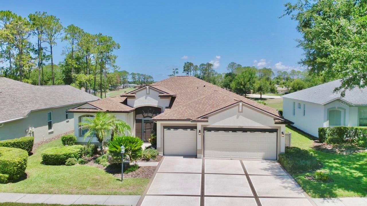 GOLF COURSE VIEW in the popular 55+ gated golf community of Heritage Pines.  Offered FURNISHED OR UNFURNISHED.  With 4 bedrooms, 3 full baths, + 3-car garage this home offers over 2200 sq. ft. of  comfortable living space. Architectural enhancements include crescent window, high ceilings, plant shelves & archways.  Upon entering the home through the screened front porch with glass front door you’ll have an unobstructed view of the golf course from the combination formal living room / dining room with sliders leading to the lanai.  Just beyond  is the open dinette area and kitchen overlooking the family room with lots of natural light. Meal prep will be a breeze in the full appointed kitchen complete with breakfast bar, all appliances, disposal, built-in desk, abundant 42” cabinets, recessed lighting, & double door pantry filled with roll-out shelves. The primary suite with tray ceiling & access to the lanai has 2 walk-in closets and an en-suite bath complete with dual sinks, WALK-IN TUB, walk-in shower, and private toilet. With a split bedroom plan providing lots of privacy & multi-generational living possibilities,  bedrooms 2 & 3 near the front of the home share bath with tub/shower combination.  Bedroom #4 at rear of home with additional access to the lanai  has its own bath with a shower.  Very functional laundry room including washer / dryer / laundry tub / + cabinetry for storage. The screened lanai with tile plank flooring was extended to not only provide shaded seating area, but also room for relaxing in the sun. GENERATOR 2024. ROOF 204. A/C 2015. Sinkhole remediation completed in 2013.  All docs available. You’ll find endless resort style amenities at Heritage Pines including clubhouse, community pool, fitness center, library/computer room, golf shop, tennis, bocce court, golf course, horseshoes, spa facilities ….. just to mention a few.  Shopping, dining, & medical options close by. And with easy access to the Suncoast Parkway, you’re only a short drive to all that the Tampa Bay area has to offer.  Call for your private showing today and start enjoying the Florida lifestyle!
