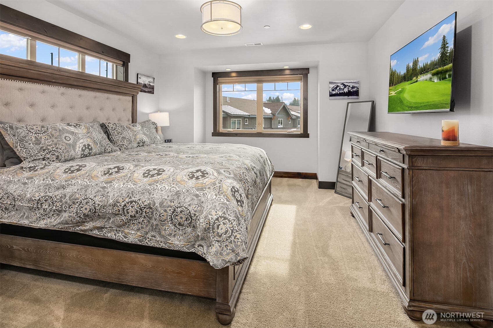 Primary bedroom with King Bed, ceiling fan, walk in closet and ensuite bath. Large TV