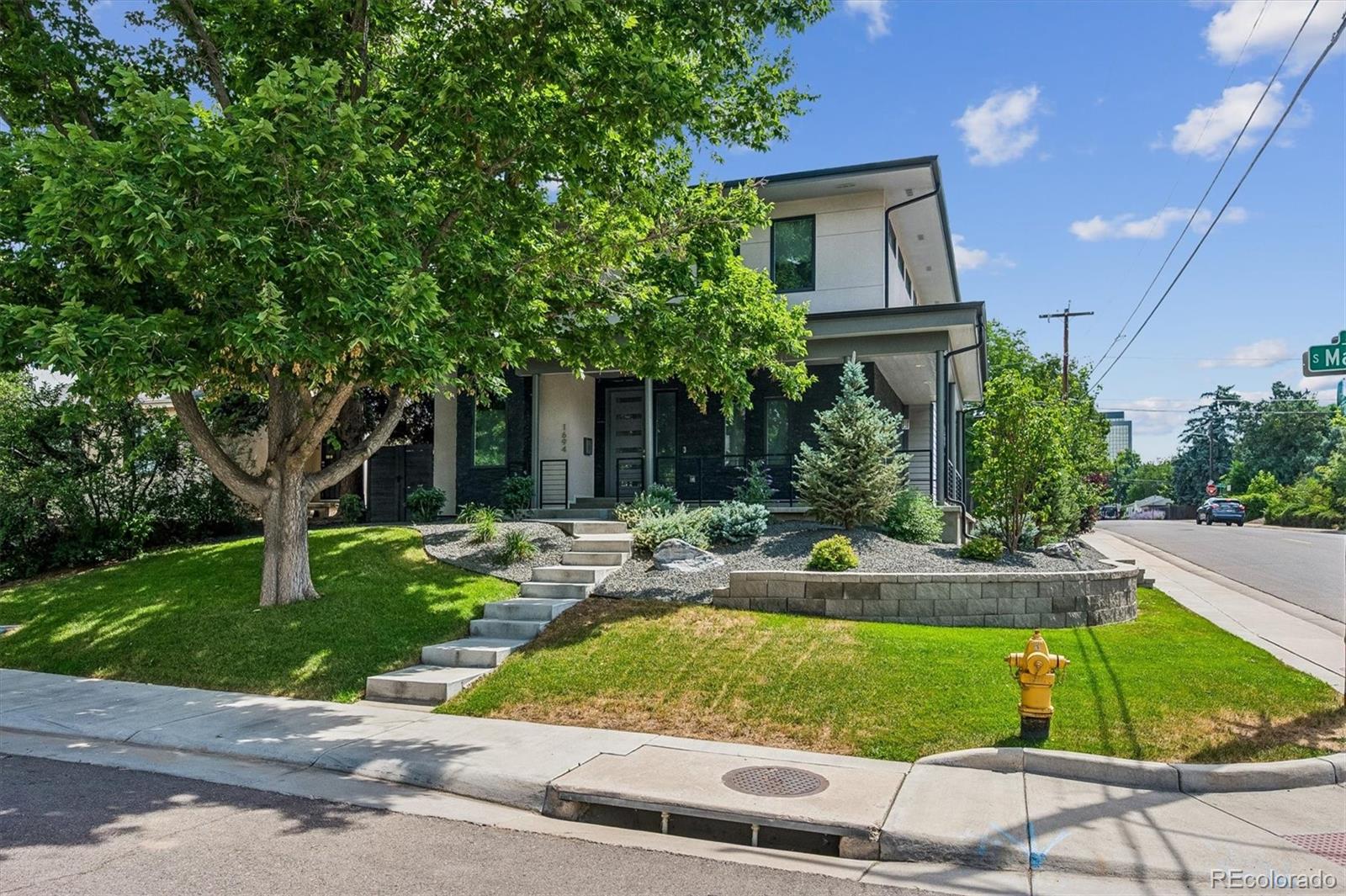 Beautiful 2017-built custom home in coveted Cory-Merrill. This meticulously maintained 6-bed, 4-bath residence offers over 4,400 sq ft on a landscaped corner lot. Rare, attached garage so no walking outside during bad weather. Also rare for area has a very private and useable backyard! Wraparound front porch, hardwood main level, and a double-sided fireplace welcome you in. The gourmet kitchen features an oversized island, gas cooktop, double ovens, and walk-in pantry, flowing to a French-door dining room that opens to the porch. Main-floor bedroom ideal for guests or office. Upstairs primary suite boasts a private mountain-view balcony, dual vanities, and walk-in closet, plus 2 more bedrooms and a convertible loft. Finished basement adds 2 bedrooms, a full bath, dry bar, and rec room. Rare attached oversized two-car garage, Nest thermostat, mesh Wi-Fi, and tankless water heater. Zoned for Cory Elementary & Merrill Middle (just 1 block away), Minutes to Cherry Creek North, Wash Park, DU, Whole Foods, and I-25. Move-in ready. The rest of the professional photos coming Saturday 7/25, delayed due to storm Thursday.