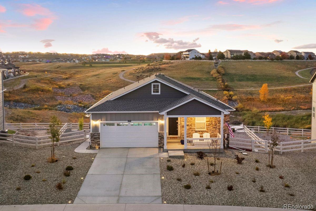 Set on a spacious lot backing to open space, this five-bedroom ranch home captures the beauty of Colorado living. Natural light and open views define the interior, where a bright white kitchen, main-floor primary suite, and finished walk-out basement offer modern comfort. From morning coffee on the deck to afternoons at the Recreation Center—complete with a pool, fitness center, and park—this Crystal Valley home connects every moment to the landscape that surrounds it. As you arrive, views of the open space immediately capture your attention, framing a charming front porch that sets the tone for what’s inside. Step through the front door to a bright hallway that flows into the kitchen and living room. The kitchen shines with white cabinetry, a large quartz island with breakfast bar seating, Whirlpool appliances, a stainless steel undermount sink, pantry, and a perfect nook for a coffee bar. The dining area comfortably seats 4-6 and opens through sliding doors to the walk-out deck, where meadows and rolling hills stretch into the distance. The family room feels warm and inviting, centered around a SimpliFire remote-controlled gas fireplace with tile surround, while plantation shutters throughout the home add style, privacy, and light control. The main-floor primary suite offers both brightness and calm, with open-space views and an ensuite featuring dual sinks, a walk-in shower, private water closet, and walk-in closet. Three additional bedrooms share a full bath, while the laundry room connects conveniently to the two-car garage. The newly finished walk-out basement adds an extra bedroom, full bath, and a spacious recreation room ready for entertaining or relaxation—complete with more natural light and scenic views. Outside, a storage shed and low-maintenance yard with a small grassy patch make upkeep simple. Overlooking meadows, hills, and a pond that attracts local wildlife, this home captures the very best of peaceful Colorado living. OPEN HOUSE SAT 10/18 1–3pm