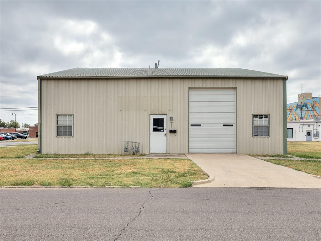 Rare downtown-adjacent opportunity on a high-visibility corner lot at 220 N Crawford, just blocks from the heart of downtown Norman. This versatile steel building lives as two completely independent spaces under one roof, with no interior connection between them, and each side is built to face customers. Each unit opens from its own private street entrance into a finished, carpeted showroom/office room with natural light: a professional, client-ready front space perfect for retail, a studio, a reception area, or offices. From there, each side flows back into its own work space, and each has its own overhead drive-in door and its own ADA-accessible restroom.Behind the front room, the two sides offer different strengths. One is a turn-key working shop — open and clear-span under steel trusses with a built-in workbench, adjustable wall shelving, a steel storage cabinet, a heavy-duty stainless utility/wash sink, and a freestanding enclosed room for a private office or secure storage. The other is a tall, open warehouse anchored by a custom wood-framed mezzanine and full staircase that add a second level of usable space for storage, studio, or office overflow, with the loft above and covered area beneath. That layout is what makes this property so flexible: run a storefront or office up front and production, service, or storage in back, on either or both sides! Occupy one unit and lease the other, or hold both as separate income units. Both sides share the corner site and dual street frontage, all within walking distance of downtown Norman's restaurants, retail, breweries, and arts and entertainment district, and minutes from the University of Oklahoma. Durable concrete floors, high clear-span ceilings, natural light, and separate utilities round out an ideal fit for a retailer, service business, contractor, creative studio, or investor. Buyer to verify all measurements, utilities, zoning, and permitted uses.