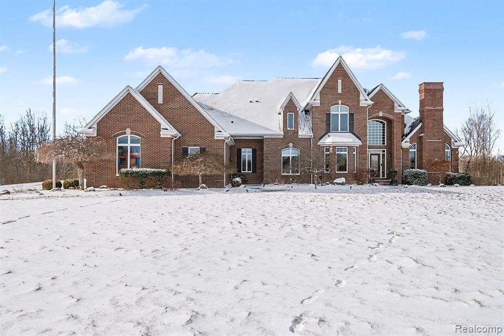 Welcome to a truly exceptional custom brick estate where space, craftsmanship, and natural beauty come together on 30 breathtaking acres. This impressive 5-bedroom, 3.5-bath home offers 4,584 square feet of thoughtfully designed living space, complemented by a 4.5-car garage and a large pole barn—perfect for hobbies, storage, or equipment. Step inside the soaring foyer and be greeted by an abundance of natural light streaming through large windows, highlighting the home’s neutral aesthetic and timeless appeal. The open, expansive kitchen is a dream for both everyday living and entertaining, featuring granite countertops, a Viking refrigerator, and seamless flow into the breakfast nook, where a covered patio invites you to enjoy peaceful pond views. The family room centers around a cozy fireplace, creating a warm gathering space, while a main-floor home office provides the ideal work-from-home setup. Dual laundry rooms—one on the main level and another upstairs—add everyday convenience.Upstairs, the spacious primary en suite is a private retreat with a large walk-in closet and a luxurious bathroom featuring a sunken tub. The unfinished lower level boasts 15-foot ceilings, offering endless possibilities for a large recreation area, home gym, or entertainment space. Outside, the property is nothing short of remarkable, featuring a beautiful pond with a sandy beach, wide-open acreage, and serene views in every direction. Recent updates include new paint, a new tankless water heater, one new AC unit, a new well bladder tank, and a Generac generator for peace of mind. This rare offering combines refined living with the freedom of country space—an extraordinary place to call home.