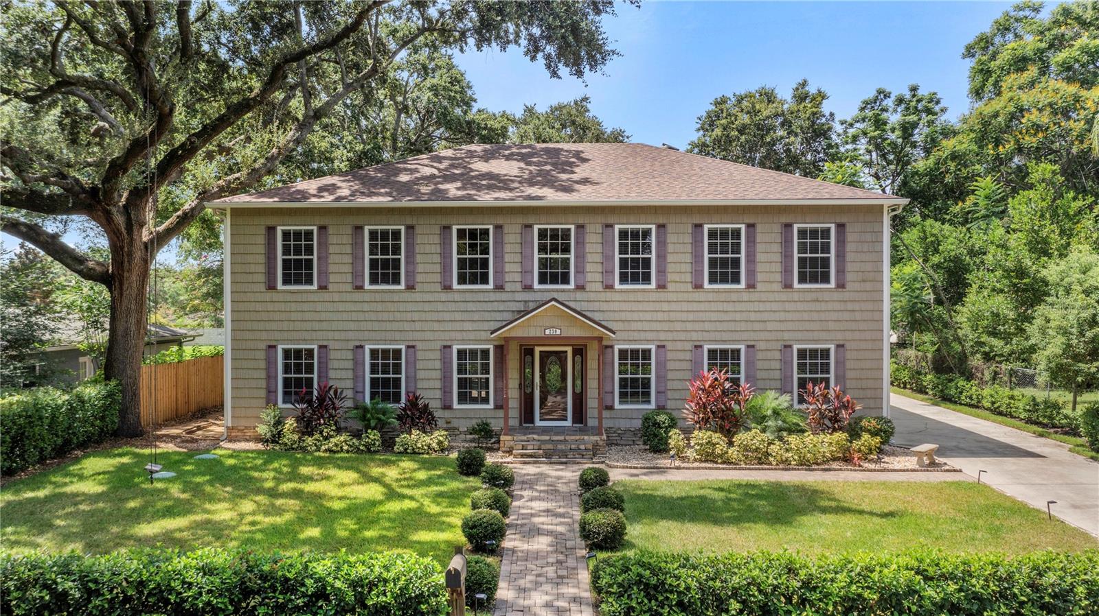 Under contract-accepting backup offers. Tucked away on a quiet private road lined with mature trees, this beautifully updated pool home offers the ultimate in privacy, flexibility, and functionality—with no HOA restrictions and just minutes from vibrant Downtown Orlando. Set on a spacious lot, this property boasts an oversized 3-car side-entry garage plus additional storage, perfect for vehicles, toys, tools, or hobbies. The newer roof (March 2022), two newer Rheem A/C units, and a newer septic system and drain field provide peace of mind for years to come. Step inside to find a unique and flexible layout featuring a main-floor primary suite with its own private entrance to the pool and lanai—ideal for multigenerational living or guests. The 1st floor primary features a large en suite bathroom with a walk-in shower and  a spacious walk-in closet.  Plus there is a 1st floor bonus room that would make a great office, playroom or den. Upstairs, you'll be welcomed by an expansive great room with a cozy wood-burning fireplace and an open-concept layout. The kitchen features solid wood cabinetry, quartz counters, stainless steel appliances, a gas range and a large island, and plenty of space for entertaining. There is also a laundry room with utility sink for added convenience. The upstairs primary suite is a true sanctuary with a spacious walk-in closet and en suite bathroom complete with a free-standing soaking tub, dual vanities, a large walk-in shower with stunning tilework and dual shower heads. Two additional spacious bedrooms and a full bath complete the well-designed upper level. A custom metal staircase leads to the beautifully designed screened-in, heated saltwater pool, perfect for year-round enjoyment. The covered patio features a hot tub and a fabulous summer kitchen and bar, making it an entertainer’s dream. Plus there is an outdoor pool half bathroom. A 500-gallon buried propane tank and generator hookup with included portable generator ensure you're ready for anything. Zoned for desirable Pershing K-8 and Boone HS!  And walking distance to Cornerstone K-12 Charter Academy! Great location minutes to downtown, SODO and just down the street from Lake Gatlin!
