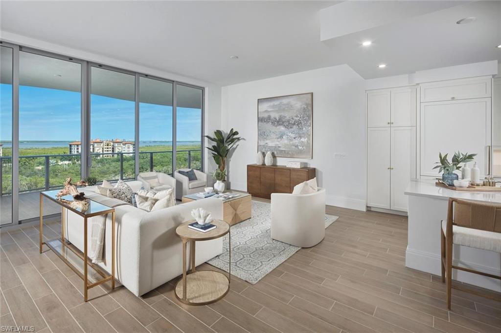 Ideally positioned on the 8th floor, this residence captures beautiful views of the Gulf and Bay and offers the perfect setting for sunset dining on the spacious lanai complete with a built-in gas grill. A private elevator entry welcomes you inside, where a well-designed layout enhance the open living spaces.  All suites face west and provide direct access to the lanai. Ready for immediate occupancy. Residents enjoy an incredible collection of resort-style amenities including a rooftop sunset terrace, pickleball courts, beach-entry pool, poolside café with food and bar service, dedicated lap lanes, fire pit lounge areas, elevated hot and cold plunge pools, par-3 putting course, day cabanas, bocce lawns, yoga lawn, dog park, social rooms, fitness center, movie theater, game room, and guest suites for visiting family and friends, along with 24-hour front desk service. Private 2-car garage included. Living at The Colony also provides access to the private waterfront Bay Club with two levels of dining, as well as Pelican Landing’s private 34-acre island beach and pavilion, tennis, pickleball, bocce, sailing, canoeing, and kayaking. Just minutes to shopping, dining, and a quick trip to the airport.