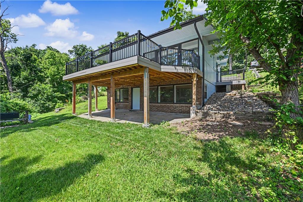Completely renovated from top to bottom, this beautifully updated 3-bedroom, 2-bath home offers turnkey lake living in the heart of Lake Lotawana. Every detail has been thoughtfully redesigned, blending modern finishes with the relaxed charm of lake life. The open and inviting floor plan is ideal for both everyday living and weekend entertaining, while large windows fill the home with natural light and frame breathtaking lake views. Step outside onto the newly finished 13' x 29' deck, where you'll enjoy panoramic views of the water and the peaceful rhythm of lake life. It's the perfect place to sip your morning coffee as the lake comes to life, watch boats cruise by throughout the day, or unwind with shaded evening dinners overlooking the water. An electric tram provides effortless access to the lake, making every waterfront adventure convenient and enjoyable. The property also includes shared ownership of a covered double-well dock with exclusive use of one boat slip complete with a boat lift, giving you immediate access to everything Lake Lotawana has to offer. Whether you're searching for a full-time residence or the perfect weekend escape, this move-in-ready home delivers the ideal combination of modern luxury, low-maintenance living, and breathtaking lake views. This is more than a home—it's the Lake Lotawana lifestyle you've been waiting for that starts today!
