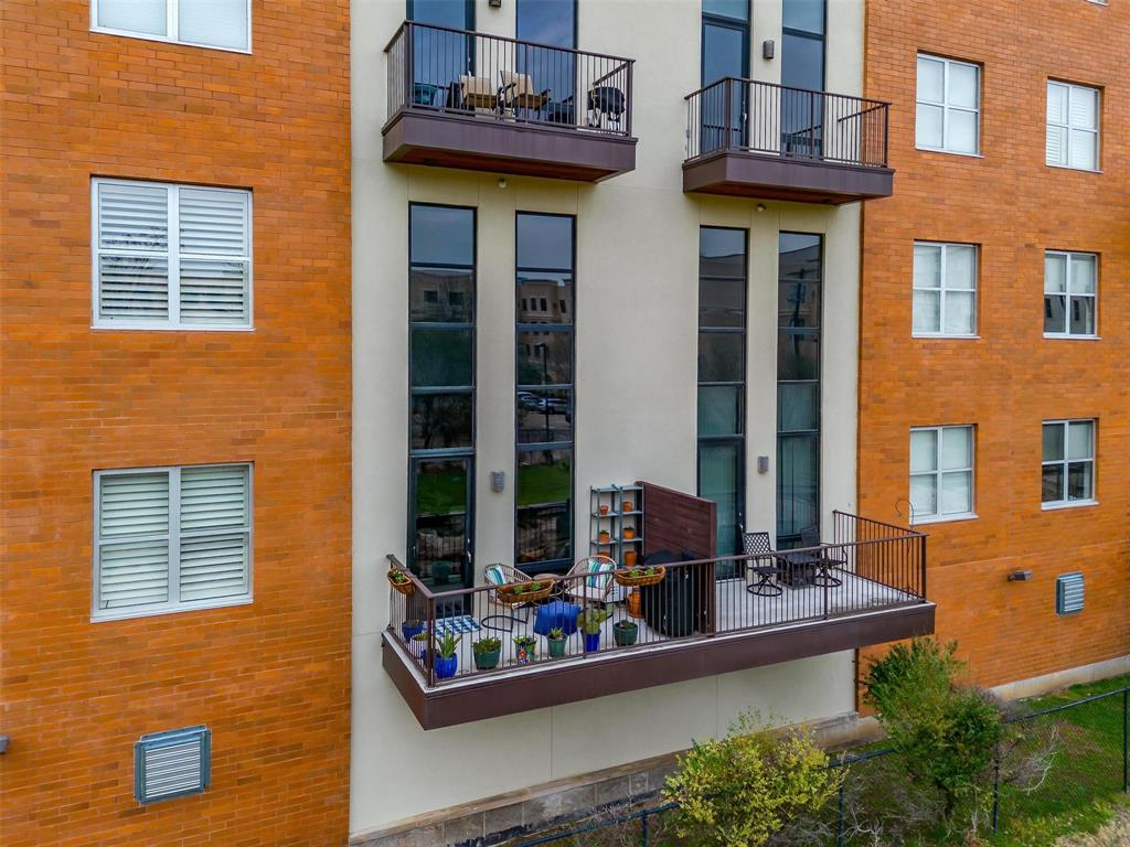 WELCOME into this stylish Fort Worth condo, where abundant natural light, thoughtful design, & an unbeatable lock-and-leave lifestyle come together. The dramatic 20-foot window wall is sure to WOW, filling the open-concept living space with morning sun & afternoon shade. The split-bedroom layout offers privacy, while the expansive primary loft bedroom gives you room to create your ideal retreat ~ space for a workout area, desk, bookshelves, music corner, whatever inspires you! The gorgeous bathroom suite feels like a vacation getaway, while low-maintenance Art Deco concrete flooring adds distinctive character. The spacious kitchen island is made for entertaining, whether you're hosting friends or serving up a delicious charcuterie spread. Step onto the balcony to enjoy stunning sunset skies, grill dinner, tend to your garden, or simply decompress after a long day. Your weekends are ready for adventure! Explore nearby art galleries & museums, try a new restaurant, walk or bike the Trinity Trails just over the ridge, grab a treat at neighborhood Summer Moon Coffee, visit Dream Park Playground for inclusive play. Enjoy designated parking, plus the best of both worlds: privacy within a community with opportunities to connect through community committees & events. Too many updates to count, here’s a teaser: designer backsplash, trendy wallpaper accents, kitchen undermount lighting, custom magnetic shutters, patio screen door, HVAC system, updated mirrors, chandeliers, & fixtures. HOA INCLUDES: Spectrum Gig-speed internet, 160+ TV channels, streaming services including Disney+, Hulu, Paramount+, Peacock, HBO Max, etc; water, trash, sewer, secured garage parking, security fob + remote system, dog run, elevators, interior fire sprinkler system, exterior blanket insurance (you pay interior contents insurance), exterior maintenance, community pool, & landscaping. THIS IS YOUR YEAR. Say YES to becoming a Fort Worth Cultural District “Condowner.” Is this your perfect match?