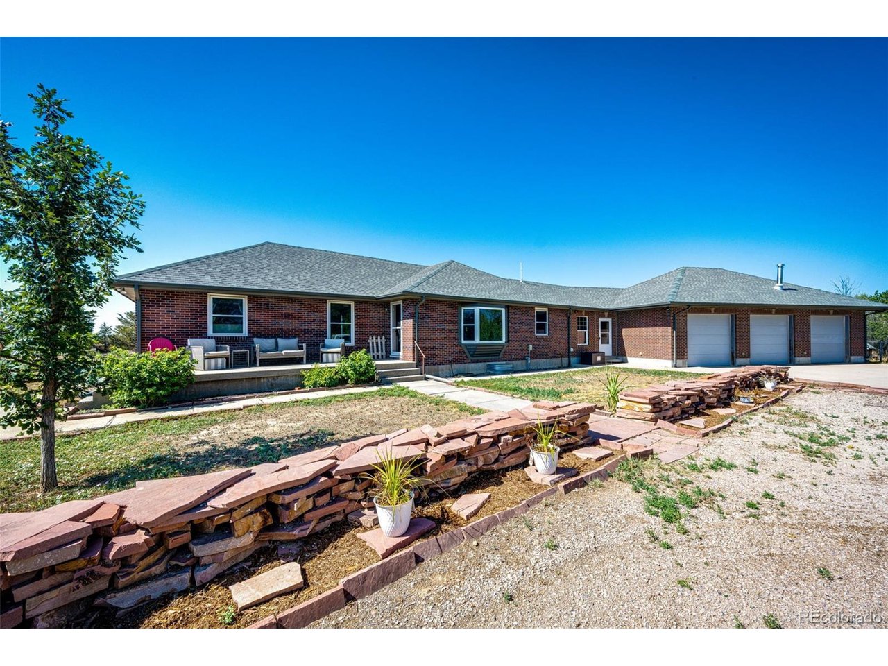 Welcome to this lovely ranch home sitting on 5.5 acres. Step inside to the bright, open, and inviting main level featuring hardwood floors throughout and large windows that bring in an abundance of natural light. The main level includes 3 bedrooms and 2 bathrooms, farmhouse style kitchen, and dedicated mudroom/laundry area.  Downstairs, the fully finished basement creates an impressive second living area, complete with its own full kitchen, two additional bedrooms and a bathroom, creating the ideal space for guests, multigenerational living, or anyone looking for an additional private living space. Enjoy your morning coffee or evenings grilling on the spacious rear deck while taking in the peaceful country setting. The property also features a chicken coop, tool shed, fenced run, play area, and one of the property's most unique features, the converted granary that has been transformed into a beautiful additional bonus space. Easy access to DIA, Denver and Brighton. Come enjoy the best of country living! For buyers looking for an even larger agricultural or investment opportunity, approximately 160 acres of farmland adjacent to the property are also available for purchase with the home. See MLS# 6979729 for more details.