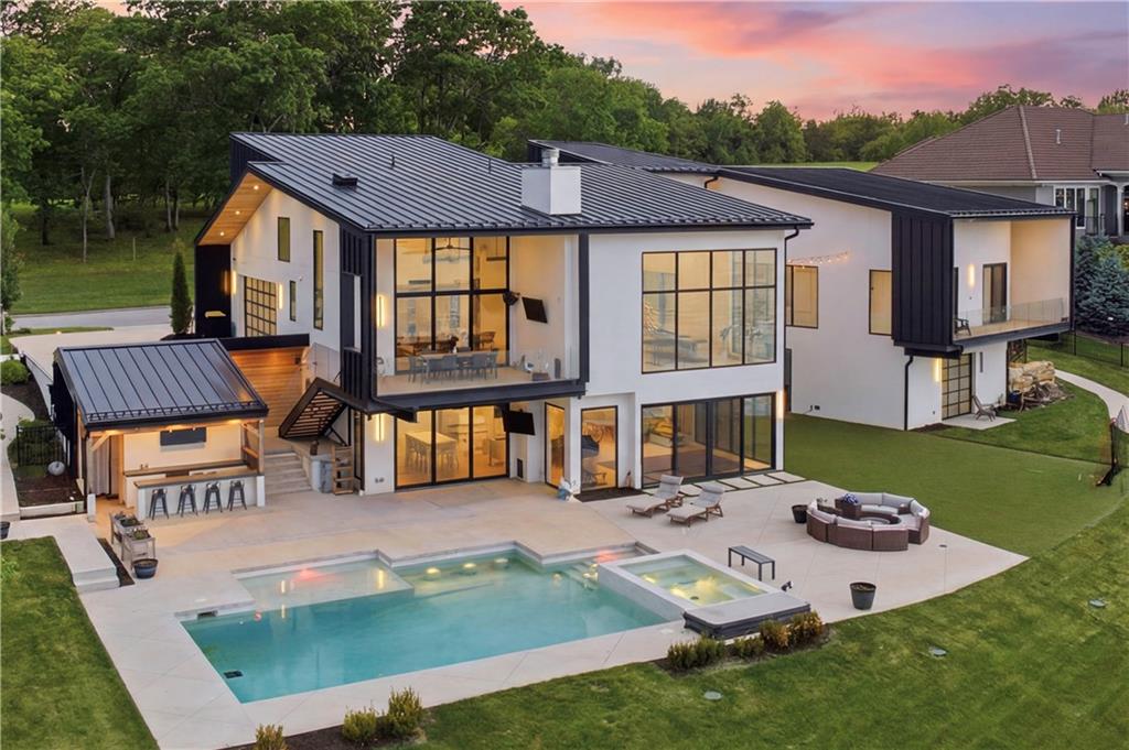 Experience the pinnacle of lakeside luxury at 16 Seminole Circle, a masterfully crafted contemporary estate on the premier shores of Lake Winnebago. Completed in 2021, this architectural masterpiece spans roughly 7,300 square feet of meticulously designed living space, where soaring ceilings and floor-to-ceiling glass walls create a seamless connection between the sleek interior and the sparkling waterfront. The open-concept floor plan is an entertainer’s dream, featuring high-end designer finishes and a gourmet kitchen that flows effortlessly into expansive living areas. Each of the 5 spacious bedrooms and 5 spa-like bathrooms offers unparalleled comfort, while the primary suite provides a private sanctuary with panoramic lake views. The outdoor oasis is truly second to none, displaying a private pool set against the backdrop of the water and a pristine lakefront lot perfect for enjoying the vibrant sunsets. This is a rare opportunity to own a nearly new, ultra-modern retreat in one of the region’s most exclusive communities.