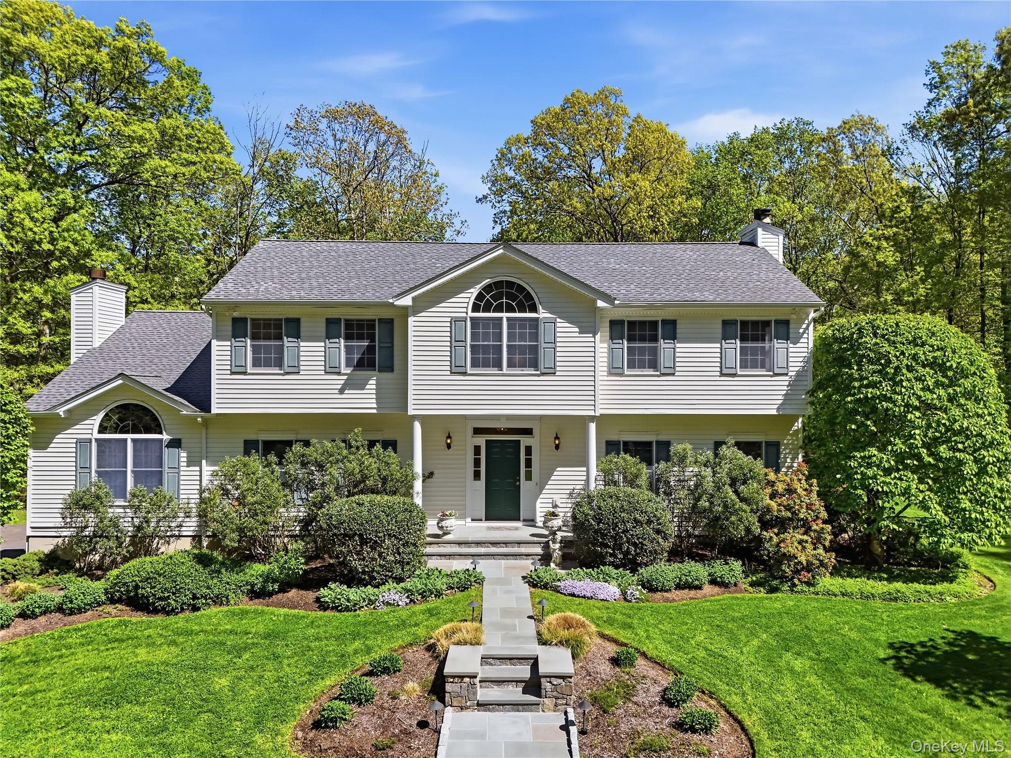 Turnkey and beautifully updated, this exceptional Center Hall Colonial offers 3 bedrooms that lives like a 4-bedroom home, with expansive, light-filled living spaces designed for both everyday comfort and effortless entertaining. Privately set at the end of a long driveway on over 5 bucolic acres, the property is surrounded by level lawns and borders hundreds of acres of protected watershed land, creating a truly serene and picturesque setting. Lovingly maintained by its original owner, the home reflects true pride of ownership throughout.Inside, soaring cathedral ceilings, oak hardwood floors throughout, and an open floor plan create a warm and inviting atmosphere. The beautifully renovated chef’s eat-in kitchen features top-of-the-line appliances, a spacious breakfast area, and doors leading to an expansive deck overlooking the tranquil property. Seamlessly connected to the kitchen is the stunning family room with cathedral ceilings and a raised-hearth stone fireplace.The first floor also includes elegant formal living and dining rooms, a light-filled office, and a second fireplace, offering flexible space for today’s lifestyle. Upstairs, the luxurious primary suite features cathedral ceilings, two walk-in closets, and a beautifully renovated en-suite bath. Two additional oversized bedrooms and another updated full bath complete the second floor.The finished lower level recreation room provides exceptional additional living and entertaining space and is complete with a sink and second refrigerator, ideal for gatherings and extended use. Outdoors, the expansive flat property offers multiple play and recreation areas, along with a charming gazebo overlooking the serene rear yard.Thoughtfully maintained and extensively updated, special features include a new roof and furnace (2023), new gutters (2020), new Bessler stairs (2024), and a new front walkway (2024). Additional highlights include a whole-house Generac generator, electric car charger, security system, and a 3-car garage. Combining timeless architectural details with modern upgrades and exceptional privacy, this move-in-ready home offers refined country living at its finest.