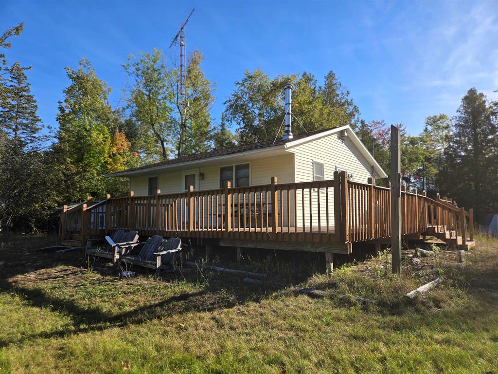 Location, location, location! This cozy 2 bedroom, 1 bathroom home is located on a beautifully wooded 25+ acre parcel adjacent to Sturgeon Point State Park. Just a half mile from public Lake Huron access, you can hear the waves while relaxing on your large wrap around deck. Wooded views in all directions with some established trails. This would make a great hunting cabin, up-north retreat, or perfectly secluded year round home. The property is ready to be enjoyed and is being sold as seen minus a few personal items.