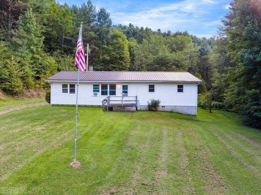 Secluded, serene, private & peaceful, 4 wooded acres with year-round small creek with 3 spring branches that feed into it & runs through the side of the land. Mostly wooded, level, easy on the legs, plenty of room to homestead, garden, hunt & play. Has private well & roof done in 2014. Home is heated by wood stove and wall heaters, cooled by window unit & the cool fresh mountain air under the shade trees that whispers through the open windows. Huge eat in kitchen, living room, den, 3 bedrooms, 1.5 baths, small rear covered porch, sunroom. separate side entry laundry room. Citizens Telecommunications for cable & internet. Home is a fixer upper and has not been lived in for quite a while. Land will be spectacular once new buyers bring in their mowers and bush hogs, as it all used to be open & groomed prior to sellers relocating. Its just so pretty and private back here on this land and the land is the true star and gem of this listing for sale. The home needs TLC and a new family to bring it back to its prior glory but this property is a fantastic value for that buyer with a vision & fortitude to be a homeowner & savvy for a sweet deal who has the simple desire to start their own dreams with some hammer swinging, maybe a few trips to the home warehouse stores, paint, carpet, decorating and a good deep cleaning. Being sold as is. Seller making no repairs of any kind.