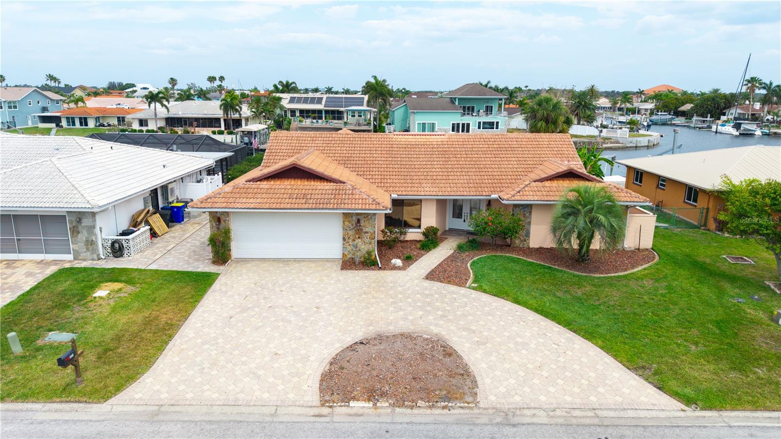The Seller has agreed to contribute $10,000.00 to the Buyer buying down their mortgage interest rate. 

This home is model perfect and ready for the next owner who wishes to live in the waterfront community of Gulf harbors. In 5 minutes, you are in the waters of the Gulf of Mexico. Many Islands to explore up and down the coast and great fishing out deep. You have at your fingertips new almost everything, new lighting in rooms that had the need, Stainless appliances in the kitchen with new cabinets and  Granite counters,
We have oversized bedrooms and closets. Floors are all new with porcelain tile, Bathroom showers all new tile with new frameless shower enclosures. The oversized garage has a small workbench area.  The great room could double as a theater room if you wish. because you have a family room as well as a formal living room.
The Laundry/utility room is perfectly placed with cabinets for folding linens and additional storage space.  The oversized garage has a small workbench area. The tile roof is in excellent condition and 24 years old with many years of life remaining.
The current dock needs repair and not big enough for that yacht you have been looking at because you have an 80 ' seawall to tie up to. All Pasco County permits have been approved and satisfied from the flooding Gulf Harbors sustained. The neighborhood has come back stronger than ever.  Our Gulf Harbors community has many clubs, crafts and activities, I promise you will not be bored. Come and have a look you will not be disappointed….
