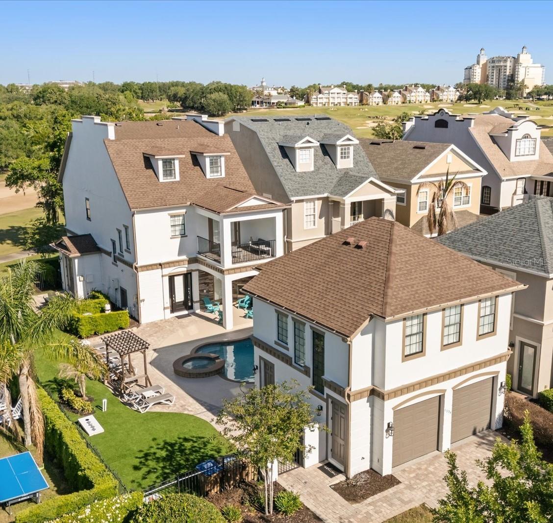 SELECT OPPORTUNITY TO SHOW ON 05/24, 05/26 and 05/27.  Luxury, Lifestyle and Legacy- The best parts of owning, living and vacationing in Reunion are on display at this Sunset Stunner!  Welcome to 1536 Corolla Court in the heart of Reunion’s Liberty Bluff Community.  This is A RARE 3 STORY HOME that showcases the “POSTCARD VIEW” from multiple balconies and allows you to overlook 7 HOLES of GOLF!  The property is also WEST facing which means you will never miss another Reunion Sunset again!  Take note that the lot is larger than normal which allows for more entertaining and outdoor area.  High-end artificial turf has been installed to maximize the space.  Along with an outdoor cooking area, a freshly painted pool deck and a multiple lounging chairs-this home is a sun worshipers dream!  This type of construction and layout will make you feel like you are getting 2 properties for the price of one.  Inside the first property you will find a fully equipped fun zone on the first floor filled with high-end gaming systems.  There is a private entrance just for the first floor and it is walls are lined with 2 sets of French doors that let you overlook the pool area.  A custom feature in this home.  The second floor also has a private entrance.  There you will find a well-appointed space with 2 bedrooms along with a kitchenette and a separate bathroom area.  Once inside the main house you will be drawn into how much natural light is inside.  The paint tones and colors have been chosen to create a calm and relaxed feeling. The open floor plan includes an indoor and outdoor dining space, a spacious kitchen and a comfortable living room all on the first floor.  You will also find a FIRST FLOOR BEDROOM with a private bath. There is also a separate ½ bath that doubles for a pool bath.  You can access the second floor via the wood tread staircase or take your own PRIVATE ELEVATOR.  There you will find additional bedrooms, with large private balconies along with a STAR WARS themed bedroom with bunkbeds.  The THIRD FLOOR is reserved for the primary bedroom and includes its own special oversized covered outdoor balcony designated for a cup of morning coffee or an evening glass of wine. You can also see the Reunion Grande Hotel in the distance. THIS PROPERTY HAS IT ALL!  This home does come with an ACTIVE REUNION RESORT MEMBERSHIP and is in a very active and SUCCESSFUL rental program. HUGE RENTAL AND MEMORY MAKING POTENTIAL. Reunion Resort has everything you want in a community including 3 signature golf courses, world class dining, waterparks, lazy river, water slides, firework viewing areas, tree lined streets, dog park, playground, driving range, golf simulator, member events, in-resort shuttle service, and event space. Live the resort lifestyle like a VIP. NO OTHER RESORT IN THE AREA HAS THIS!!!! Minutes to Disney and close to Beaches, Universal, Legoland and Sea World. Schedule a tour today. 80 million visitors are estimated to visit Orlando in 2026.  Welcome your family and friends in this home for years to come or take advantage of the demand for a rental home like this!  BOOKINGS ALREADY IN PLACE FOR 2026!