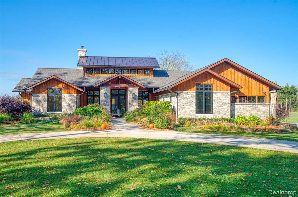 UNIQUE CUSTOM BUILT, ARCHITECTURALLY DESIGNED RANCH HOME SET ON 27.5 ACRES-OFFERS PRIVACY, remaining just minutes from town and freeway access-ideal for relaxation and convenience. Thoughtfully crafted with quality and comfort in mind, this property offers a rare combination of elegance, functionality, and space. The home features an IMPRESSIVE Great Room with soaring ceilings, a conversation area in front of the unique stone fireplace, and a wet bar perfect for entertaining. Solid walnut wood flooring enhances the warmth of the home, and the large dining area flows seamlessly into the open kitchen, creating a warm and inviting space for both large and intimate gatherings. The finished basement offers an ample space for gaming, another wet bar, a full bath, and an area for your workouts or yoga sessions. As a bonus, there is an ELEVATOR to utilize if needed, between floors, and it is right off the kitchen. Outdoors, you'll find five well-maintained barns totaling over 8,000 square feet, each with lighting and water access. The 41'x60' horse barn includes four stalls, a tack and equipment area, and upper-level hay storage, all in excellent condition that any horse enthusiast will appreciate. Surrounded by open acreage, mature trees, and peaceful views, this property offers a unique opportunity to own a one-of-a-kind ranch estate, thoughtfully crafted with versatility in mind and with room to breathe, work, and play.